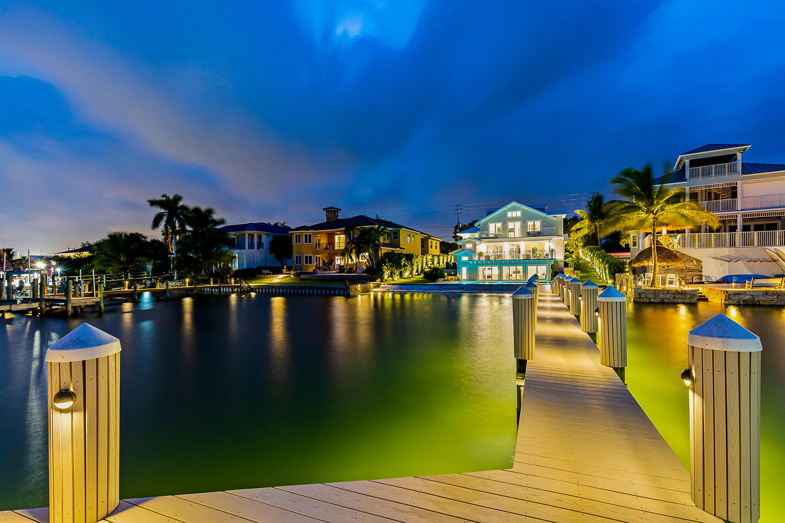 Welcome to your breathtaking Intracoastal Blue Water Estate built in 2021 with direct ocean access and no fixed bridges. Nestled along the shimmering blue waters of the Intracoastal Waterway, this beautiful fully furnished home features a rare sandy-bottom private beach which is ideal for swimming, paddleboarding, or simply lounging as boats drift by, and plenty of room for multiple water crafts. Designed for both entertaining and escape, the property includes, two separate guest retreats, each complete with its own kitchen, living room, bedroom, and full bath — perfect for hosting family or friends in comfort and privacy, plus boasts two spacious main-floor bedrooms, while the expansive primary suite offers a luxurious bedroom, a cozy sitting room with a wet bar .. and ice maker, and a large private balcony overlooking the pool, patio and stunning water views all accessible from an elevator that services all 3 floors. Whether you're seeking a peaceful getaway or a vibrant waterfront lifestyle, this estate delivers elegance, comfort, and unbeatable access to the best of coastal living.  Ask for a more detailed sheet of fabulous features such as generator, camera system, smart home and much much more.