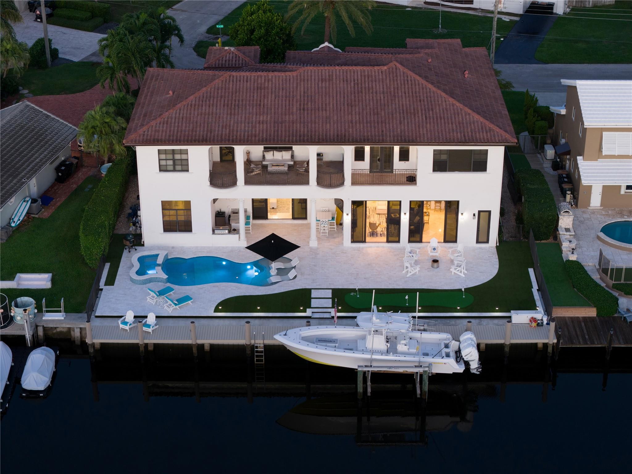 Recently re-imagined Deepwater Estate sited on 90’ of waterfrontage in sought-after Lighthouse Point. This custom estate reveals 5 beds + Office, 4.1 baths & 5,211+/- Living SqFt. Transcend through light-filled interiors comprised of a formal living room, wine cellar, family room and updated modern kitchen w/luxe Wolf appliances. Upstairs there is a spacious primary suite complete with newly outfitted closets and a spa-like bath. Other amenities include impact windows & doors, 4 zone A/C, 3 bay garage, 48kw gas generator, putting green, Sonos sound system, & more. Outdoor entertainment is enjoyed at the refinished heated pool with sun shelf & spill-over spa. A brand-new seawall anchors a composite yacht dock with 16,000 lbs lift – ideal for avid boaters just minutes to the Hillsboro Inlet. DISCLAIMER: Information published or otherwise provided by the listing company and its representatives including but not limited to prices, measurements, square footages, lot sizes, calculations, statistics, and videos are deemed reliable but are not guaranteed and are subject to errors, omissions or changes without notice. All such information should be independently verified by any prospective purchaser or seller. Parties should perform their own due diligence to verify such information prior to a sale or listing. Listing company expressly disclaims any warranty or representation regarding such information. Prices published are either list price, sold price, and/or last asking price. The listing company participates in the Multiple Listing Service and IDX. The properties published as listed and sold are not necessarily exclusive to listing company and may be listed or have sold with other members of the Multiple Listing Service. Transactions where listing company represented both buyers and sellers are calculated as two sales. “No payments made until title passes” Some affiliations may not be applicable to certain geographic areas. If your property is currently listed with another broker, please disregard any solicitation for services. Information published or otherwise provided by seller, listing company or its representatives is deemed reliable but are not guaranteed and subject to errors, omissions, or changes without notice. Copyright 2025 by the listing company. All Rights Reserved.