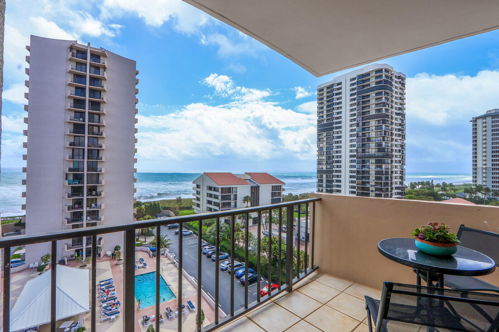 Relax and enjoy the view from this southeast corner residence on the warm, sunny side of Cote D'Azur Tower 2. This 2-bedroom condo offers a large, open living and dining area perfect gatherings. The updated eat-in kitchen features granite countertops. Step out to your private east-facing balcony overlooking the pool deck and ocean — ideal for morning coffee or unwinding at sunset. Both bedrooms have direct terrace access. The updated master bath includes a separate tub and shower, and the spacious guest bedroom adds flexibility. An interior laundry room comes equipped with a full-size washer and dryer. The unit is fully furnished and move-in ready.njoy ocean views  by day and stunning Intracoastal Waterway views in the evening. All sliding doors are equipped with hurricane shutters for peace of mind.  Additional details: Covered Parking Space #145C located under the tennis courts. Storage Locker #47 included.  Building amenities: Heated pool on an elevated deck between the towers with a shade pavilion, fitness workout room, sauna, and tennis.