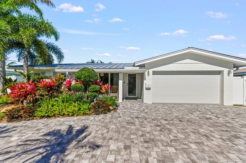 Completely renovated waterfront retreat offering the ultimate South Florida lifestyle with ocean access, 70' of water frontage, just one fixed bridge (approximately 12-14 foot clearance) and only 20 minutes to the ocean. Perfectly positioned along one of Pompano Beach's scenic waterways, this exceptional residence blends luxury, peace of mind, and modern coastal living with every major upgrade already completed. From the moment you arrive, the home's tropical landscaping, clean curb appeal, and contemporary finishes create an inviting first impression.  No expense has been spared throughout this extensively updated home.  Major improvements include a 2024 standing seam aluminum roof, 2024 A/C with all-new ductwork, upgraded 200-amp electrical panel, impact windows and doors, replaced cast-iron plumbing, brand-new flooring, professionally installed maintenance-free turf, and a new 2025 seawall built to meet current code requirements through 2035. Boating enthusiasts will appreciate the private dock featuring a 2025 20,000-pound, 37-foot boat lift, providing easy access to the Intracoastal and Atlantic Ocean.  Inside, bright open living spaces are filled with natural light and designed for effortless entertaining. The thoughtfully designed floor plan seamlessly connects the living room, dining area, and designer kitchen, complete with marble countertops, solid wood cabinetry, new appliances, elegant lighting, and contemporary finishes throughout. Spacious bedrooms and beautifully renovated bathrooms create a warm yet sophisticated atmosphere, while the luxurious primary bath features a relaxing steam shower for a true spa-like experience.  Step outside into your own private backyard resort featuring a newly installed heated pool and spa, expansive patio, lush maintenance-free turf, and a beautiful tiki hut, creating the perfect setting for entertaining, relaxing, or enjoying waterfront living year-round. Large sliding glass doors seamlessly blend indoor and outdoor living while showcasing tranquil water views.  Additional highlights include a FEMA Flood Zone X designation, offering added peace of mind, and a prime location just minutes from pristine beaches, waterfront dining, shopping, golf, marinas, and everything Pompano Beach has to offer. This truly turn-key waterfront home offers the rare combination of luxury finishes, extensive mechanical upgrades, exceptional boating amenities, and an unbeatable location.