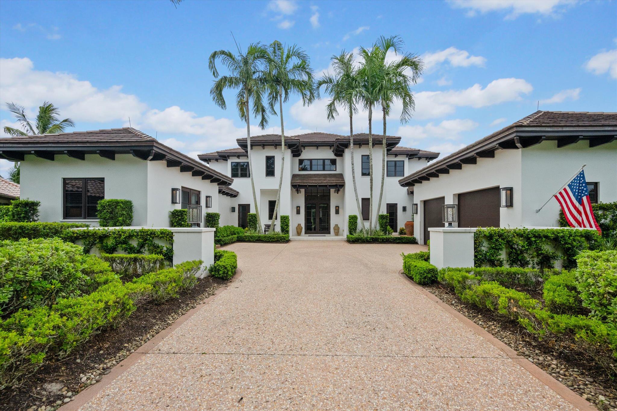 Experience the Loxahatchee Club lifestyle in the prestigious award winning community, where world class amenities meets luxury and tranquility. This extraordinary 4,736 square-foot home offers breathtaking views of the serene lake and manicured golf course. Designed for sophisticated comfort the main house features three spacious bedrooms plus a den, four full bathrooms, and two half baths. A detached guest house adds versatility with an additional bedroom and full bath, perfect for hosting or as a private retreat. Entertain effortlessly in the expansive living, dining, and family rooms, each appointed with designer finishes that complement the panoramic vistas. The gourmet kitchen stands as a culinary masterpiece, boasting top-of-the-line appliances and a layout that marries functionality with impeccable style. At the heart of this residence is a luxurious infinity pool, serving as a tranquil oasis amidst lush landscaping and stunning views. The primary suite is a sanctuary, featuring dual walk-in closets and two complete bathrooms, one for each of the two primary bedroom residents that rivals a five-star resort. Upstairs, two generously sized guest suites ensure every visitor feels pampered and at home.