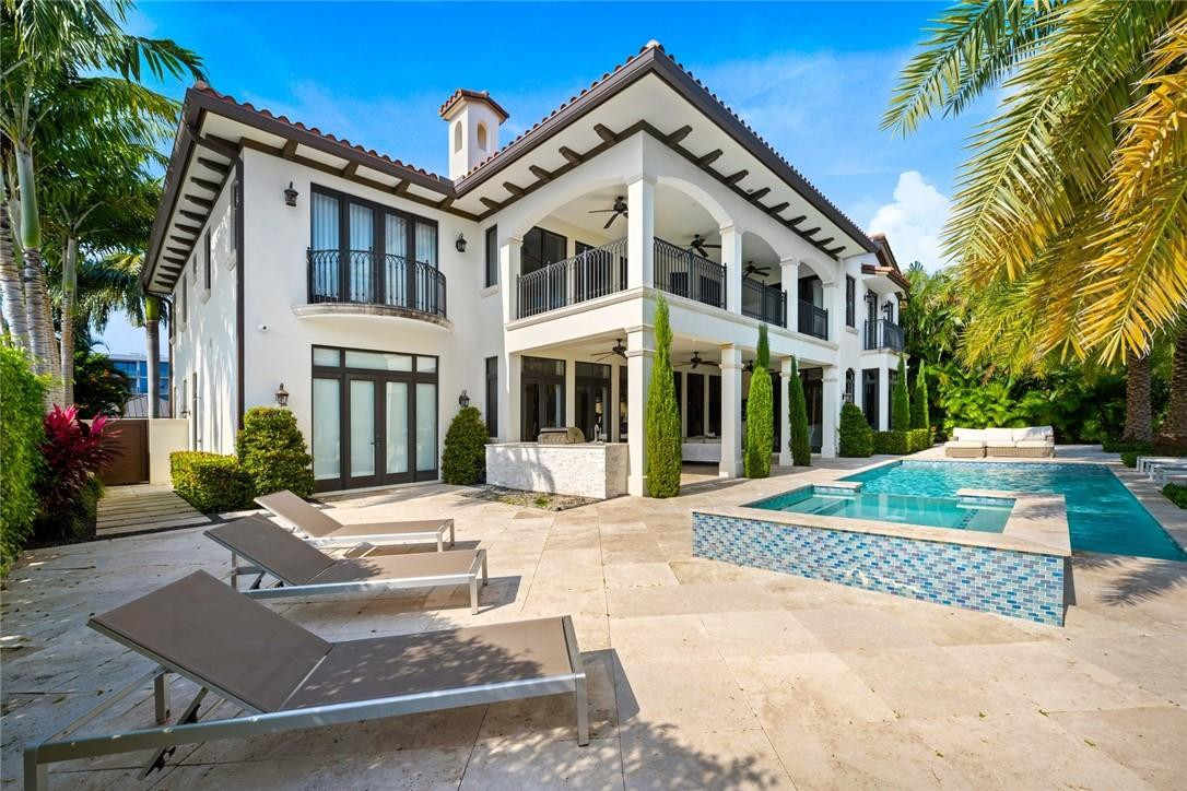 Offered turnkey & available for a quick closing! Stunning transitional custom deep-water residence offers Eastern exposure, resort style grounds, pool & spa, summer kitchen & 95' of deep-water frontage. The professional interior design offers a welcoming coastal modern vibe & open flow that is perfect for entertaining!  Elegant entry foyer, 2-story living room & fireplace, adjoining formal dining room & expansive great room, breakfast area with large & well-equipped Chef's kitchen (all water facing). home office & potential bedroom on first level, 2 laundry rooms,custom lighting & drapery throughout. Grand staircase/elevator to 4 spacious bedrooms & incredibly well proportioned primary suite, sitting area, ultra-luxurious spa bath & large custom closets, access to oversized covered balcony
