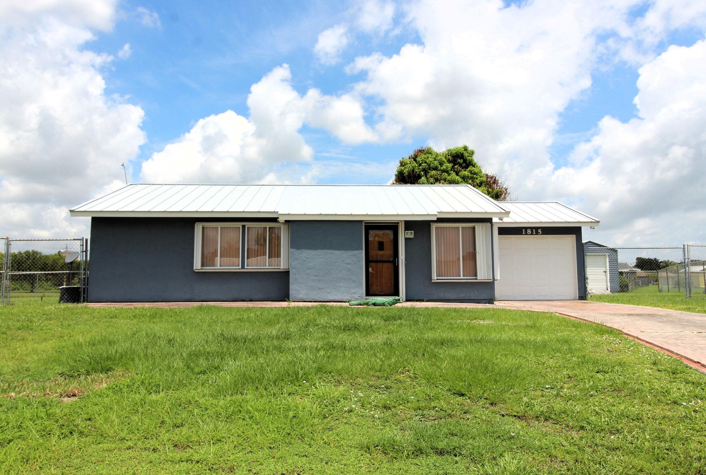 Charming 2-Bedroom, 2-Bath Waterfront Home. Located on a quiet cul-de-sac east of US-1, this inviting home features a newer roof, granite kitchen countertops, a separate laundry room, full hurricane shutters, single-car garage, fenced yard, and a storage shed and a mature mango tree. Relax on the huge screened porch overlooking a peaceful pond. Conveniently located near shopping, dining, hospitals, schools, recreation, and beautiful Treasure Coast beaches. Don't miss this waterfront opportunity!