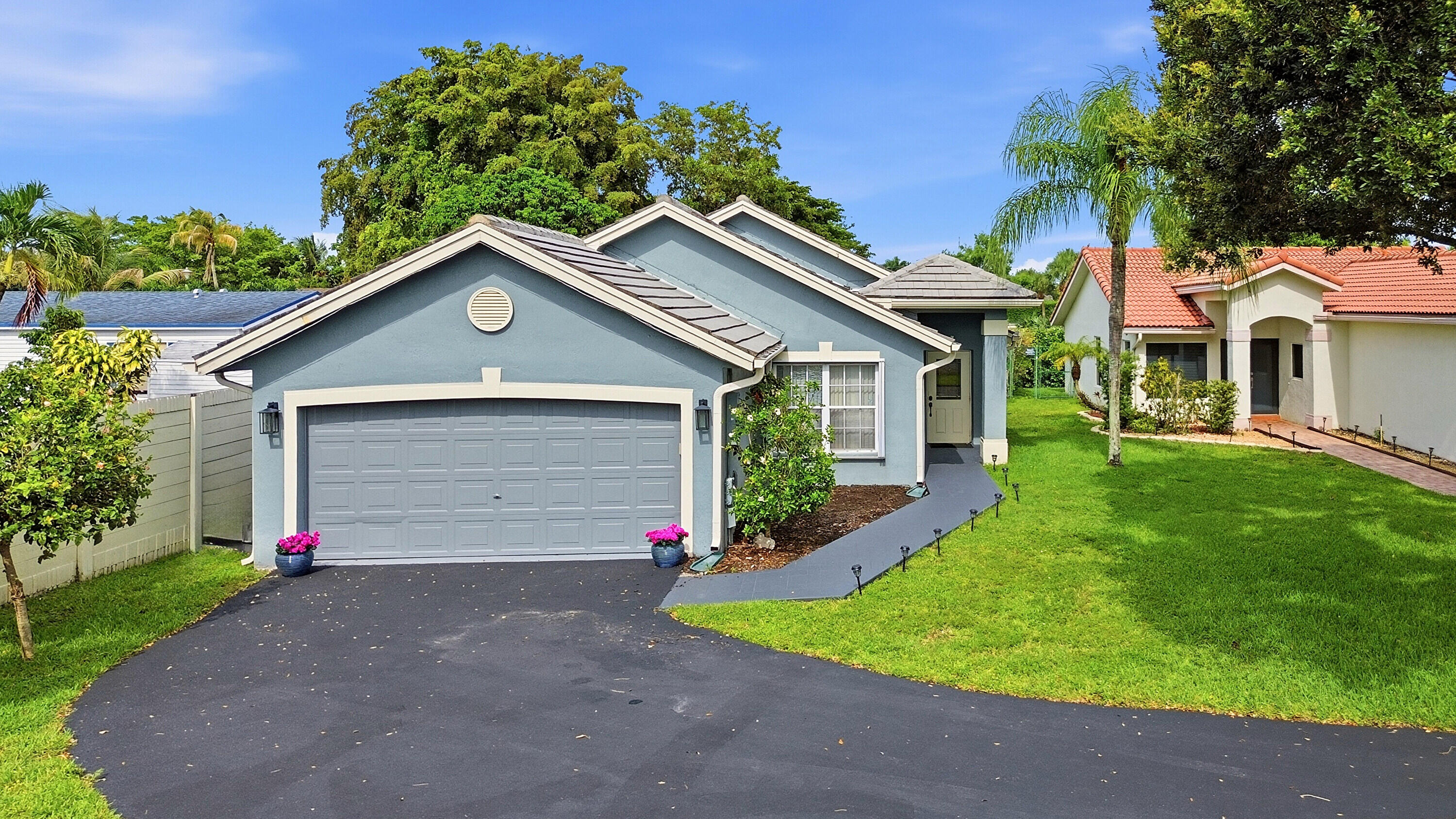 Tucked away in the highly sought-after Arboretum, this beautifully maintained single-story residence offers the perfect blend of modern upgrades and effortless South Florida living. From the moment you pull into the oversized driveway, the curb appeal of the classic tile roof and manicured 9,540-square-foot-lot sets a welcoming tone. Inside, the 2,000-square-foot-layout feels bright and airy, designed for both daily comfort and effortless hosting. Peace of mind comes standard here, vinyl flooring, along with spacious master bedroom and large walk-in-closet. The heart of the home flows seamlessly toward the outdoors, where a large patio provides a shaded sanctuary for weekend gatherings or quiet mornings overlooking the expansive backyard. Rare opportunity MOVE-IN-READY!! MUST SEE!!