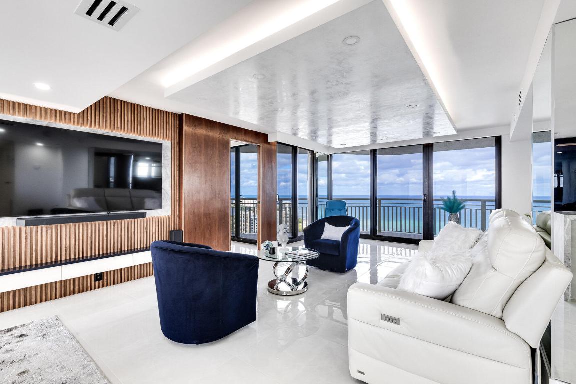Indulge in the epitome of coastal luxury with this beautifully designed and completely renovated two-bedroom, two-bathroom residence. Offering exquisite views of both the ocean and intracoastal, this home is a true sanctuary. The fully equipped kitchen and turnkey furnishings make everyday living effortless, while Venetian plaster ceilings, motorized blinds, and a sleek electric fireplace add touches of modern elegance throughout. Wake up to breathtaking sunrises and unwind with spectacular sunsets, all from the comfort of your own home. With its vacation-style ambiance and refined finishes, this property delivers a lifestyle of serenity, sophistication, and unmatched beauty.