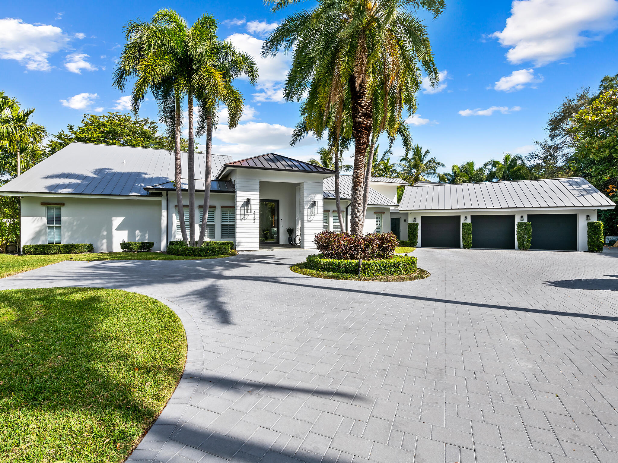Discover luxury living in this completely remodeled, contemporary home nestled on nearly one acre of lush land set within the prestigious gated community of Boca Bath and Tennis. A world of modern elegance unfolds as you enter, with a formal living area, dining room and family room with electric fireplace and a stunning new chef's island kitchen equipped with top-of-the-line appliances. The kitchen seamlessly connects to the covered patio, complete with a gas fireplace and electric screens, leading to the newly installed heated salt pool and expansive backyard with fire pit, where lush landscaping surrounds a captivating garden that has been registered as a butterfly sanctuary. With an investment of over $200,000, the garden boasts a vibrant array of flora that not only adds natural beauty but also creates a serene environment.

Additionally, this home features 5,668 living sq ft, 5 bedrooms, 5 full and 1 half bath, a playroom/den, and a grand flex room with a bar, providing abundant space for leisure and enjoyment.

Residents enjoy 24-hour manned security, a clubhouse, community pool, tennis courts, pickleball, volleyball and basketball courts, playground and acres of parks.