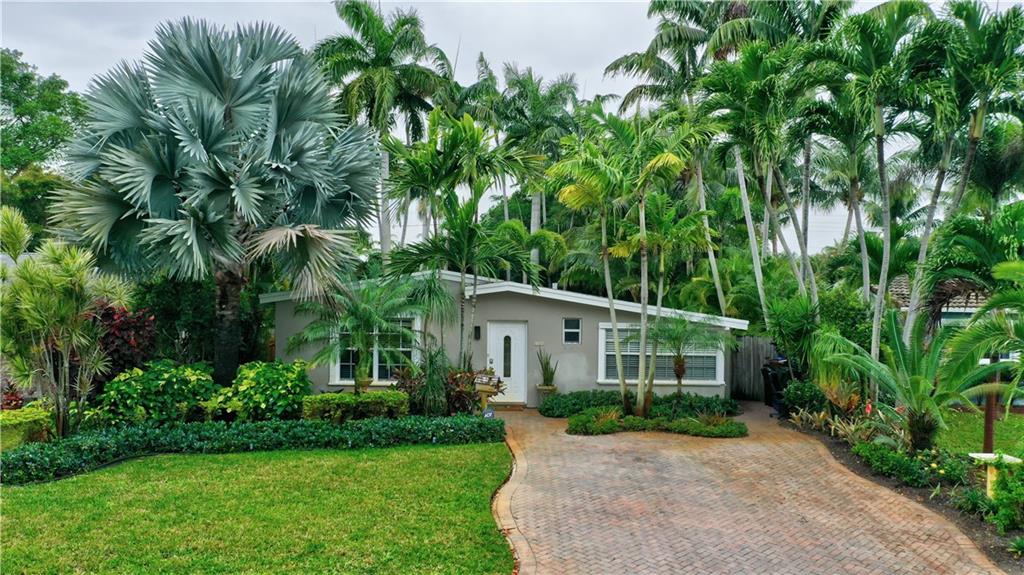 Lovely 3/2 home is sure to be the envy of Friends & Family.  Amazing curb appeal with tasteful exotic Landscaping & Oversized Paver Driveway. Open concept Living/Dining area with large oversized windows providing beautiful natural light, New LVT flooring throughout.. Corner Master Bedroom with French Doors leading out to the stunning pool area.  White & Bright Kitchen, Stainless Steel Appliances & Breakfast area overlooking the Garden.  Amazing screened in porch area.  Exquisite, Resort style yard with lush tropical landscaping, Heated Pool (2yrs on Heater with phone app), Jacuzzi Spa, Dining area & dramatic Water Feature & landscape lighting. 2yrs on A/C. Sprinklers 1 yr. Home is being sold furnished.
