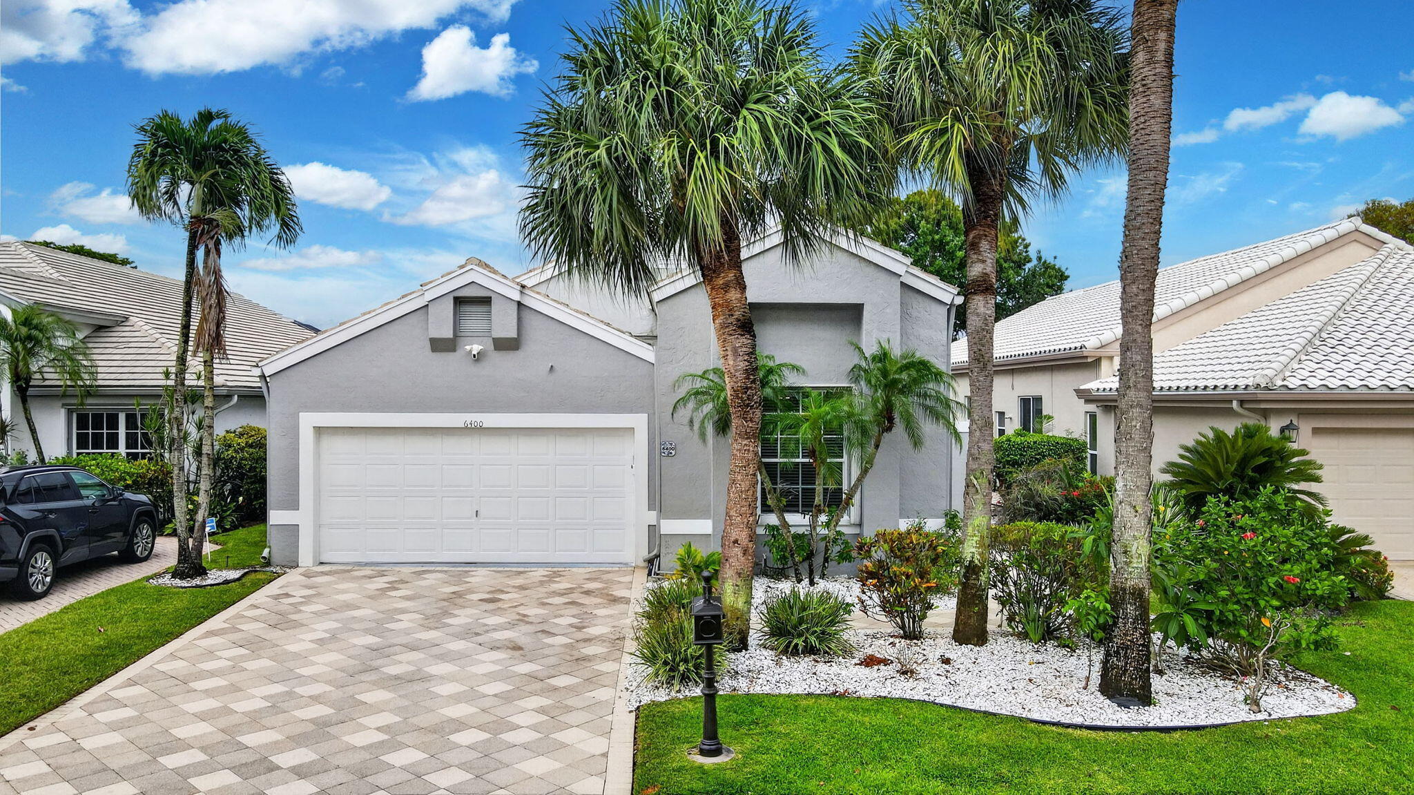 Live the Florida lifestyle in this 3 bedroom 2.5 bath house with an open floorplan and a beautiful view of the lake and fountain. The living room/ dining room combine to offer a large area for entertaining. The high ceilings accentuate the daylight that fills the room. The kitchen has stainless steel appliances, black granite countertops, drawers in all the lower cabinets, and room for a breakfast table and chairs. The primary bedroom has bamboo wood flooring and the master bath has been totally renovated. It includes a separate soaking tub and spa shower. Bedroom 3 is currently used a a den. The front hallway leads to a powder room, laundry room with newer LG washer and dryer, and a hall bath. The second bedroom is currently used as an office, but the closet  remains in place. It can easily function as a second bedroom. The flooring is ceramic tile throughout except for the master bedroom and bedroom 2 which are both wood. A covered patio leads to the back yard. It could also be screened to allow for outdoor entertaining. Maintenance covers painting of houses every 5 years, and pressure cleanng roofs and driveways, lawn maintenance and trimming of shrubbery.  This ready to move into home is a must see.  Indian Spring Country Club is a NON-MANDATORY country club. Memberships are availble for buyers who so desire.