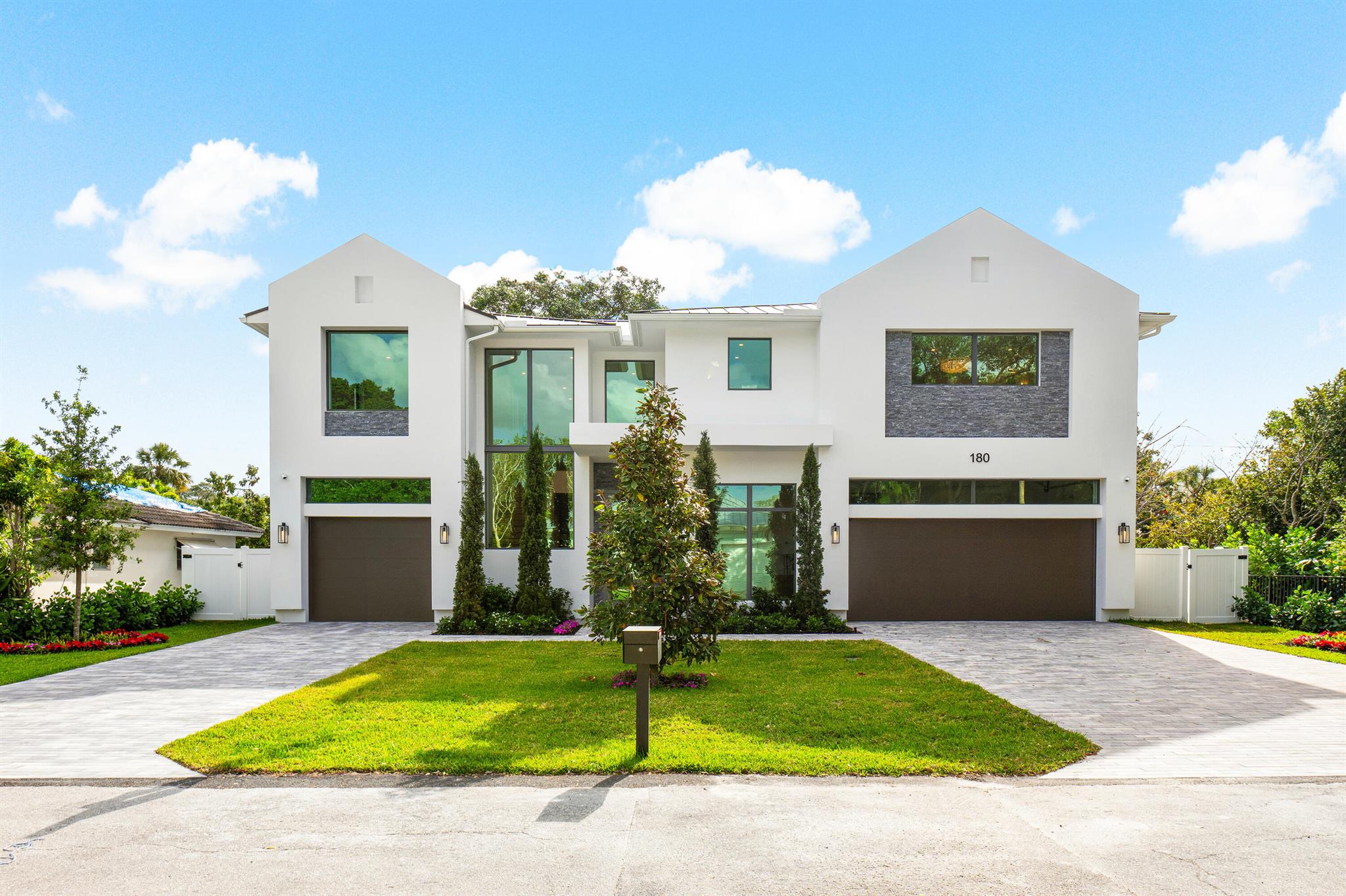 Experience the pinnacle of modern farmhouse living in this extraordinary residence by Mizner Development, where expansive open spaces seamlessly blend with the finest designer finishes and features. Thoughtfully designed for both elegance and comfort, this remarkable home boasts five spacious ensuite bedrooms, each providing the ultimate in privacy and luxury.
A dedicated office offers the perfect setting for remote work, while the club room is an inviting space for casual gatherings. The media loft presents an additional retreat for entertainment or relaxation, ensuring there's a place for every lifestyle need. The chef's kitchen is a true showpiece, equipped with top-of-the-line Wolf appliances, custom cabinetry, and a butler's pantry complete with a second sink and refrigerator— ideal for effortless hosting and gourmet preparation.
Upstairs, the primary suite is a private sanctuary, featuring exquisite finishes, and expansive custom closets. Indulge in the spa-like bathroom, where a soaking tub, oversized shower, two water closets and designer fixtures create a serene escape. A morning bar within the suite adds an extra touch of convenience and sophistication.
Step outside to your own private oasis, where a sprawling porcelain patio leads to a sparkling pool and spa, surrounded by lush tropical landscaping. The extra-deep covered patio is a true outdoor retreat, extending the home's living space and making it perfect for year-round enjoyment. A fully equipped summer kitchen completes this exceptional backyard, designed for effortless entertaining and relaxation.
Nestled in the historic and highly coveted Old Floresta neighborhood, this residence is just minutes from Mizner Park, Downtown Boca, world-class dining and shopping, pristine beaches, and the exclusive Boca Raton Resort. Tree-canopied streets invite leisurely strolls, while the area's exceptionally rated Boca schools add to the community's desirability.
This home is a rare opportunity to experience modern luxury in one of Boca Raton's most sought-after locations.