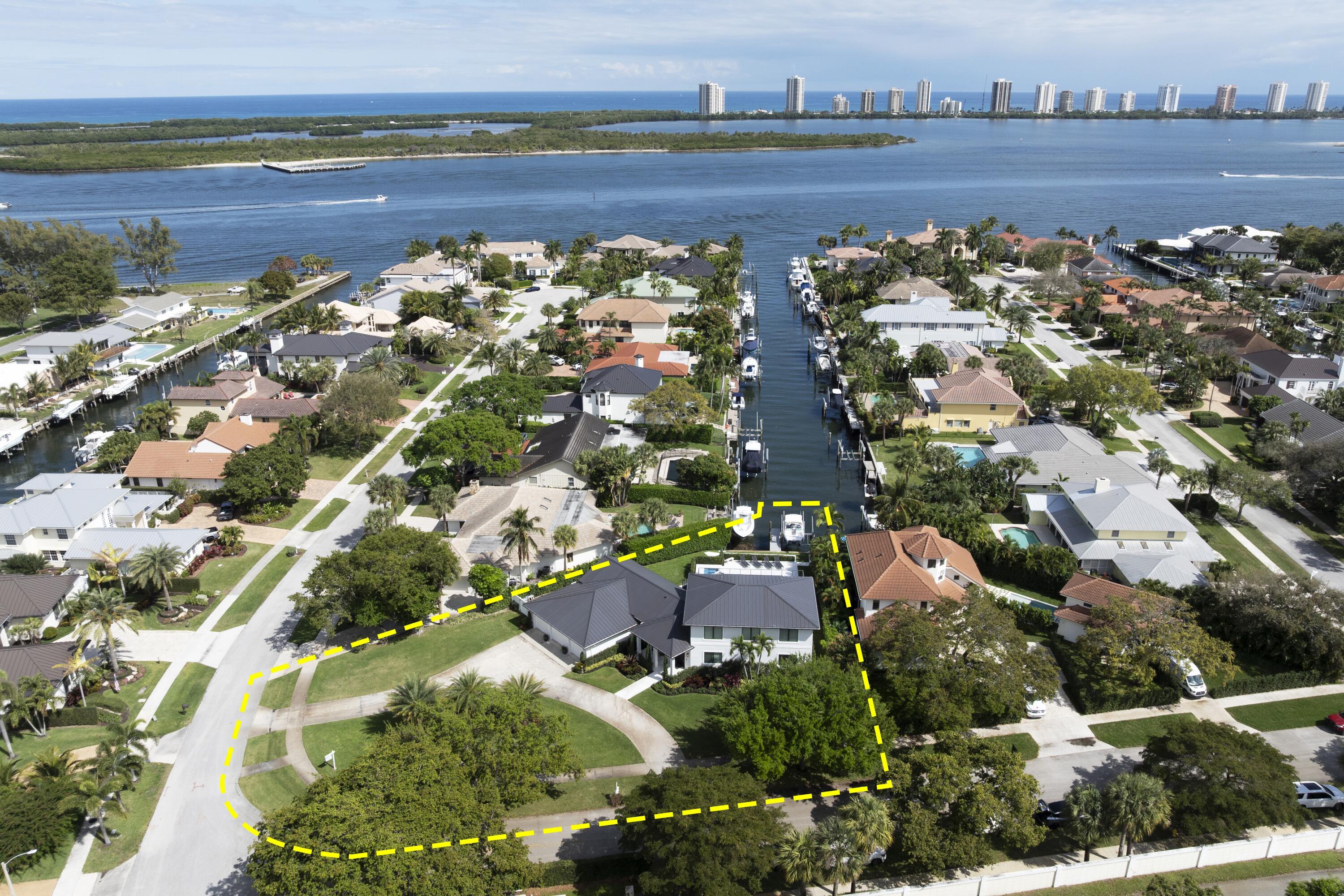 Fully renovated waterfront estate in prestigious North Palm Beach. This 4-bedroom, 5-bathroom residence spans 3,465 sq. ft. of luxury living space, offering a seamless blend of modern sophistication, comfort, and views of the Intracoastal Waterway. 

Step inside to discover a meticulously redesigned interior featuring engineered wood floors, marble and Moroccan tile flooring, soaring volume ceilings, and expansive impact-glass windows that fill the home with natural light. The grand living room (24 x 30) sets the tone for refined entertaining, while the gourmet kitchen (14 x 20), complete with a gas range, custom cabinetry, and a spacious island, is a chef's dream. The primary suite (15 x 20) on the main level is a true sanctuary, offering a private 7 x 10 sitting area, perfect for relaxation. Designed for ultimate convenience, it features his walk-in closet and her custom walk-in closet, providing ample storage in a refined setting. The spa-inspired primary bath boasts dual sinks, a luxurious soaking tub, a water closet and a separate shower, creating a serene retreat.

Upstairs, you'll find three additional bedrooms, thoughtfully arranged for both privacy and comfort. Two bedrooms share a beautifully designed bathroom, while the third bedroom boasts its own ensuite bath and private access to a stunning 13' x 36' balcony, where you can take in serene water and garden views.

Outdoors, experience resort-style living with a 15 x 30 gunite pool and spa, surrounded by sand-blasted travertine decking that stays cool underfoot. The expansive covered lanai is a true showpiece, featuring pine tongue-and-groove ceilings and a custom $7,000 phantom TV mount, blending high-end entertainment with seamless outdoor living. A covered patio with an outdoor shower and a private dock with underwater lighting, a 16,000 lb Deco Boat Lift, accommodating up to a 34' boat. Ocean access and no fixed bridges make this home a boater's paradise providing ultimate convenience.

The corner lot (19,108 sq. ft.) ensures privacy, while the circular driveway and 3-car garage provide ample parking. Additional features include a fireplace, plantation shutters, impact storm protection, and a well-fed irrigation system.

Ideally located east of US-1, this home is just minutes from Palm Beach's world-class shopping, dining, and golf courses. The Village of North Palm Beach is becoming one of the most sought-after communities in Northern Palm Beach County. It is a coastal community with easy access to both the Palm Beach and the Jupiter inlets for some of the best fishing in the world. Combined with easy access to Palm Beach International Airport, some of the best beaches and a wide range of dining establishments in the area, the village is becoming one of the top communities in Northern Palm Beach County. The Village is also home of the newly renovated North Palm Beach Country Club, featuring an Olympic swimming pool, splash pad, picnic area, an on-deck tiki hut, 200 seat banquet room, 100 seat The Grill and The Clubhouse restaurant, A Jack NicklausSignature Golf Course, and a full featured Tennis Facility with Har-Tru courts. It is open to the public and village residents.The village was recently designated as a golf cart friendly community.