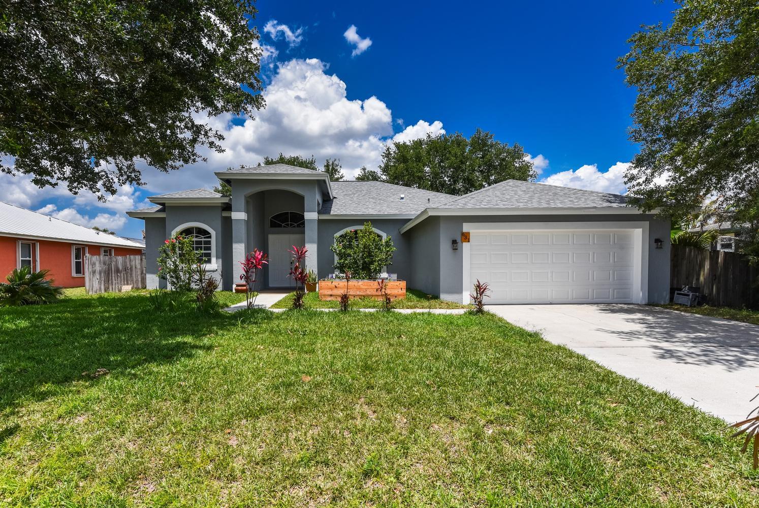 Welcome to this magnificent "Grand Home" perfectly situated in the absolute center of Port St. Lucie. From the moment you arrive, the curb appeal is undeniable, anchored by an impressive double-door grand entry that leads you into a world of space and elegance. This expansive 4-bedroom, 2-bathroom residence is designed for those who appreciate both style and functionality, featuring soaring ceilings and a freshly painted interior that provides a bright, move-in-ready canvas. The true highlight of this property is the newer roof, installed in 2025, offering the ultimate peace of mind and a significant advantage for insurance premiums. Inside, the layout flows seamlessly, offering plenty of room for entertaining. Step outside to your private oasis: a large screened-in backyard patio that opens up to a fully fenced, private yard—ideal for pets, play, or weekend BBQs in total seclusion. Location is everything, and this home puts you close to it all. You are just minutes away from world-class golf, shopping, dining, and easy interstate access, all while tucked away in a quiet, established neighborhood. This home truly offers the "Grand" lifestyle with the structural security today's buyers demand. Don't miss out on this incredible opportunity—easy to show and priced to sell!