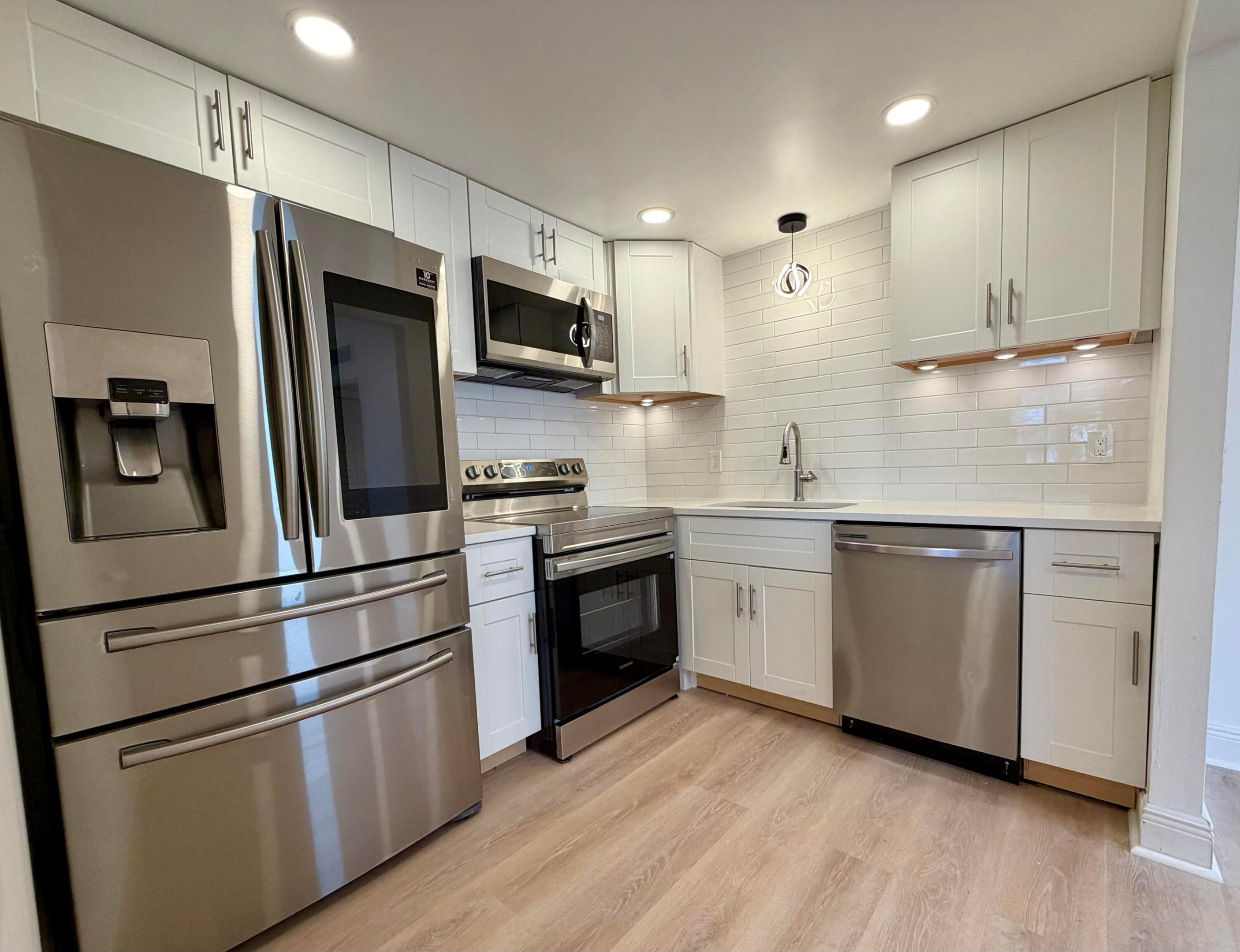 WATCH THE WALK THROUGH VIDEO!!  Golf View!  NEW: Samsung microwave, Samsung oven/stove, Samsung dishwasher.  Updated Samsung Smart Compatible refrigerator with Ice Maker ,Water and Ice Dispenser ( Fingerprint Resistant Stainless Steel}.  New cabinets in kitchen.  New quartz countertop, new white subway tile back splash, under-sink.  New high top lighting throughout, new ceiling fans living and bedroom.  New white plantation shutters living and bedroom.  New bathroom cabinets, high toilets, lighting in both.  High end vinyl plank flooring throughout.  Washer and dryer are in excellent condition.