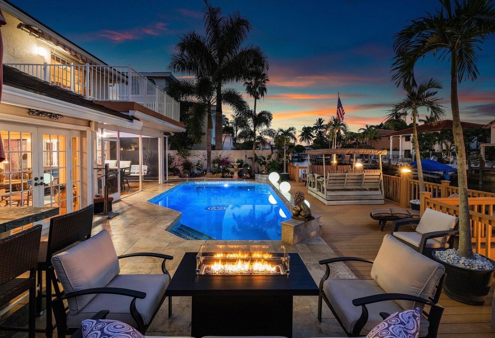 Experience the ultimate Boca Raton waterfront lifestyle in this stunning 5-bedroom, 3.5-bath residence offering 3,429 sq ft of refined living space with direct ocean access. Complete hurricane-impact protection, a new 2025 roof, and 2023 AC provide peace of mind. The thoughtfully designed floor plan features a main-level ensuite bedroom, spacious loft, and a luxurious primary suite with a private balcony overlooking the canal. Outside, enjoy a heated saltwater pool and spa, custom sauna, outdoor kitchen and bar, fire pit lounge, hot tub, screened patio, outdoor shower, artificial turf, and an expansive dock with a 12,000-lb boat lift. Ideally located near Mizner Park, world-class dining, shopping, and Boca's pristine beaches.