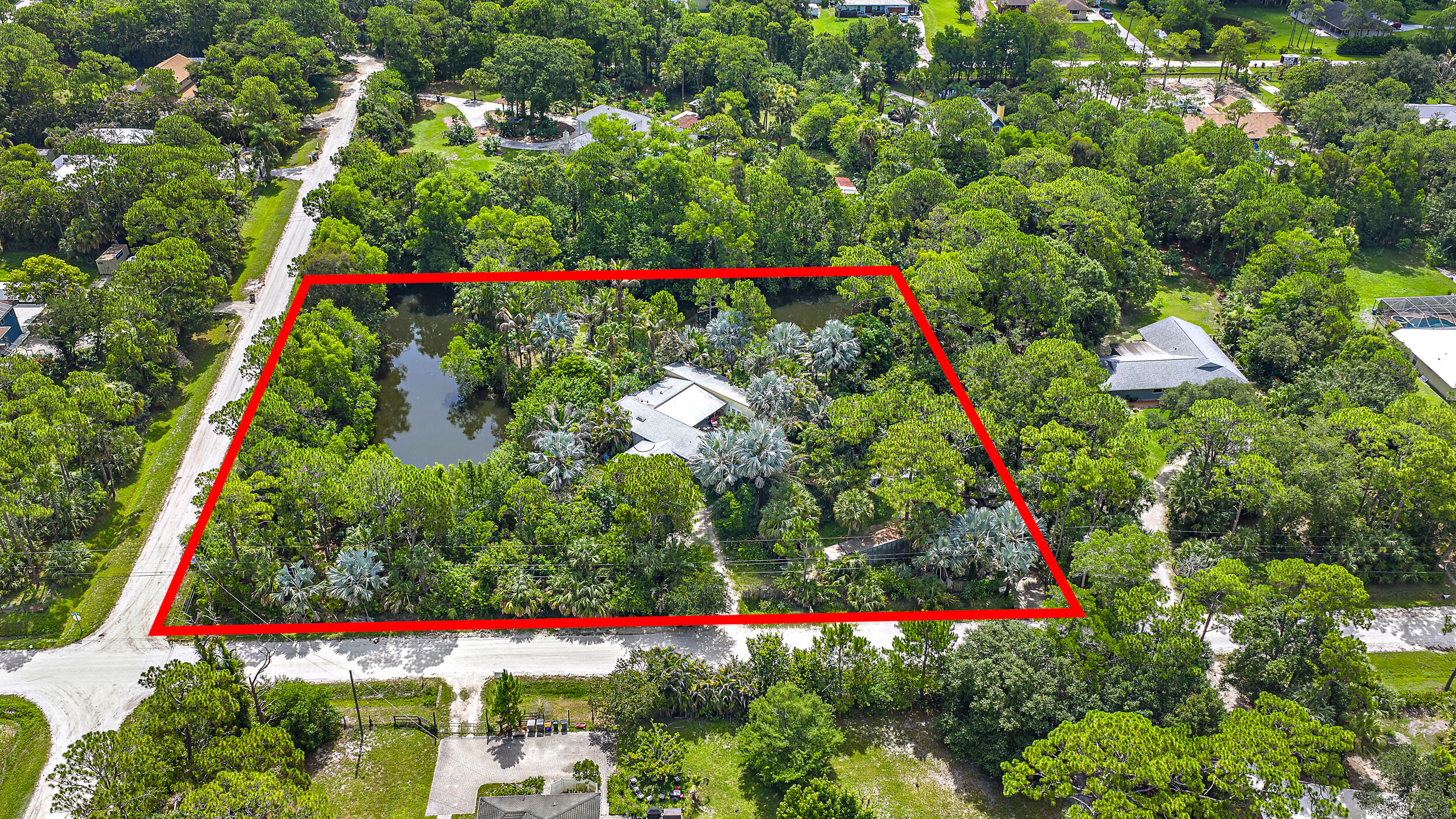 Listing price reflects lot value. Fantastic opportunity to build your dream home on 2.5 acres! 5 minutes to Publix in the front of Jupiter Farms. 100 yards off a paved road. Corner lot with a pond stocked with fish for the fishing enthusiast!