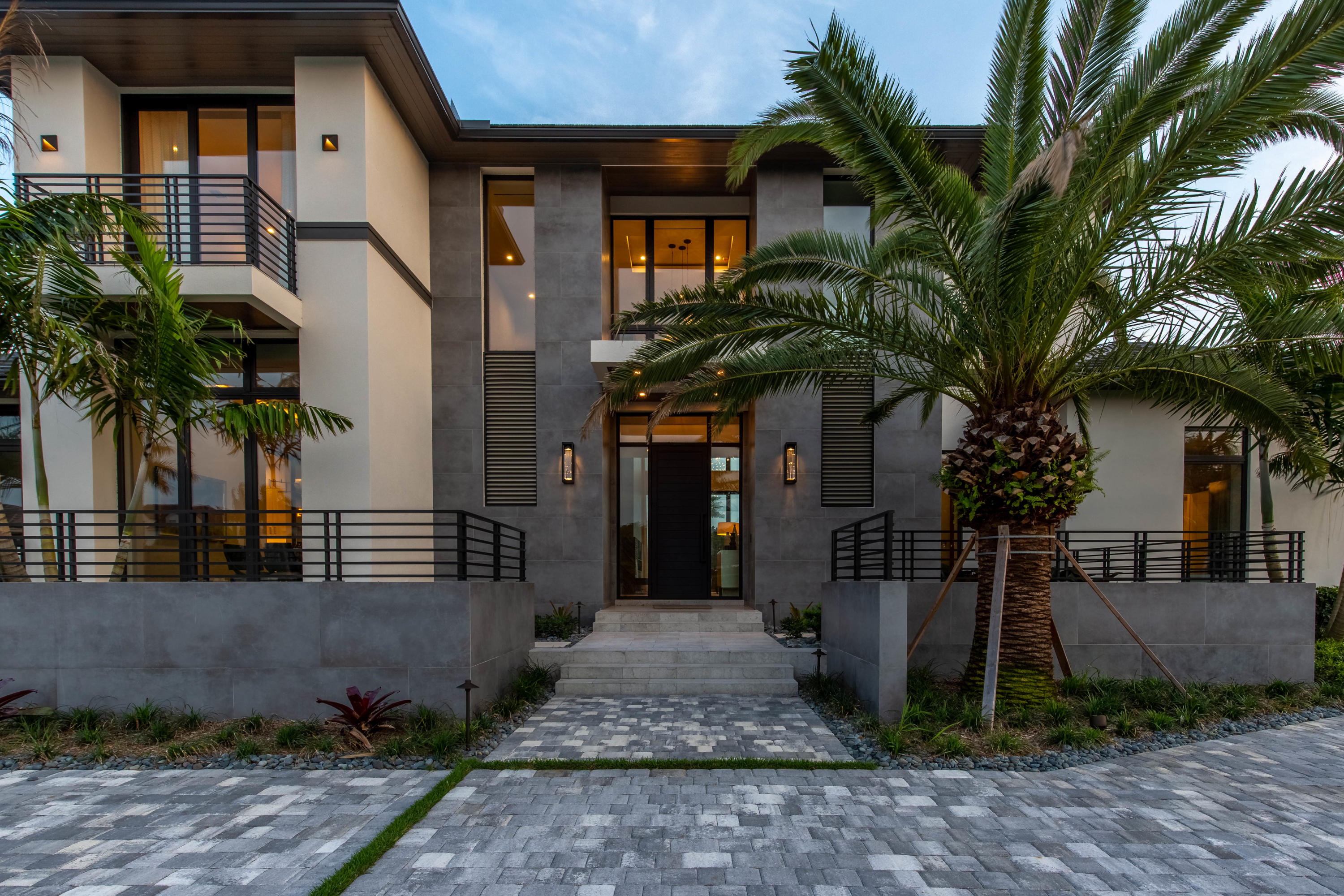 Enjoy a serene and sophisticated lifestyle in this new construction home in the stunning community of Palm Beach Polo. Boasting 7,251 square feet of living space with 4 bedrooms, 4 full baths, 2 half baths, a detached guest house, a 3 and a half car garage and an exquisite pool and outdoor living area. The striking contemporary design reflects the finest of today's architecture with flowing spaces, natural light, clean lines and bold geometric patterns. The home has been decorated by the renowned international luxury home stylists at Marc-Michaels Interior Design, and is offered fully-furnished! The main floor includes the master suite, an office, game room, and media room with a passthrough bar. In addition to the gourmet kitchen, there is a full butler's pantry and wine room. Take the elevator to the second floor where you'll find stunning views from the comfortable loft, and 3 additional guest bedrooms with full baths and walk-in closets. The guest house offers a cabana bath, gym and lounge area, and an eloquent guest suite.