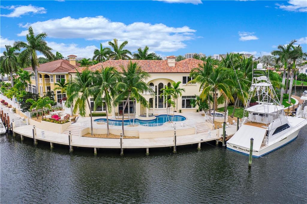 Exquisite custom built point lot in a sought after section of Lighthouse Point sitting on 170 ft of beautiful prime waterfront! With over 8000 sq ft, this 5 bedroom, 5 bath, 2 half bath home has so much to offer.  Marble floors, cathedral ceilings, elevator, great room, formal dining, fireplace and views of the water throughout. When you reach the 2nd floor, you will find a unique loft area prior to entering the bedrooms. The master suite includes a refreshment area/bar, large his and her closets,  an additional room that can be used as a sitting area or gym. Each bedroom has access to it's own balcony. New gourmet kitchen with top of the line appliances. Washer/dryer on both floors. Spectacular pool/patio with sunken bar and private spa....A house to entertain and a real boater's dream!