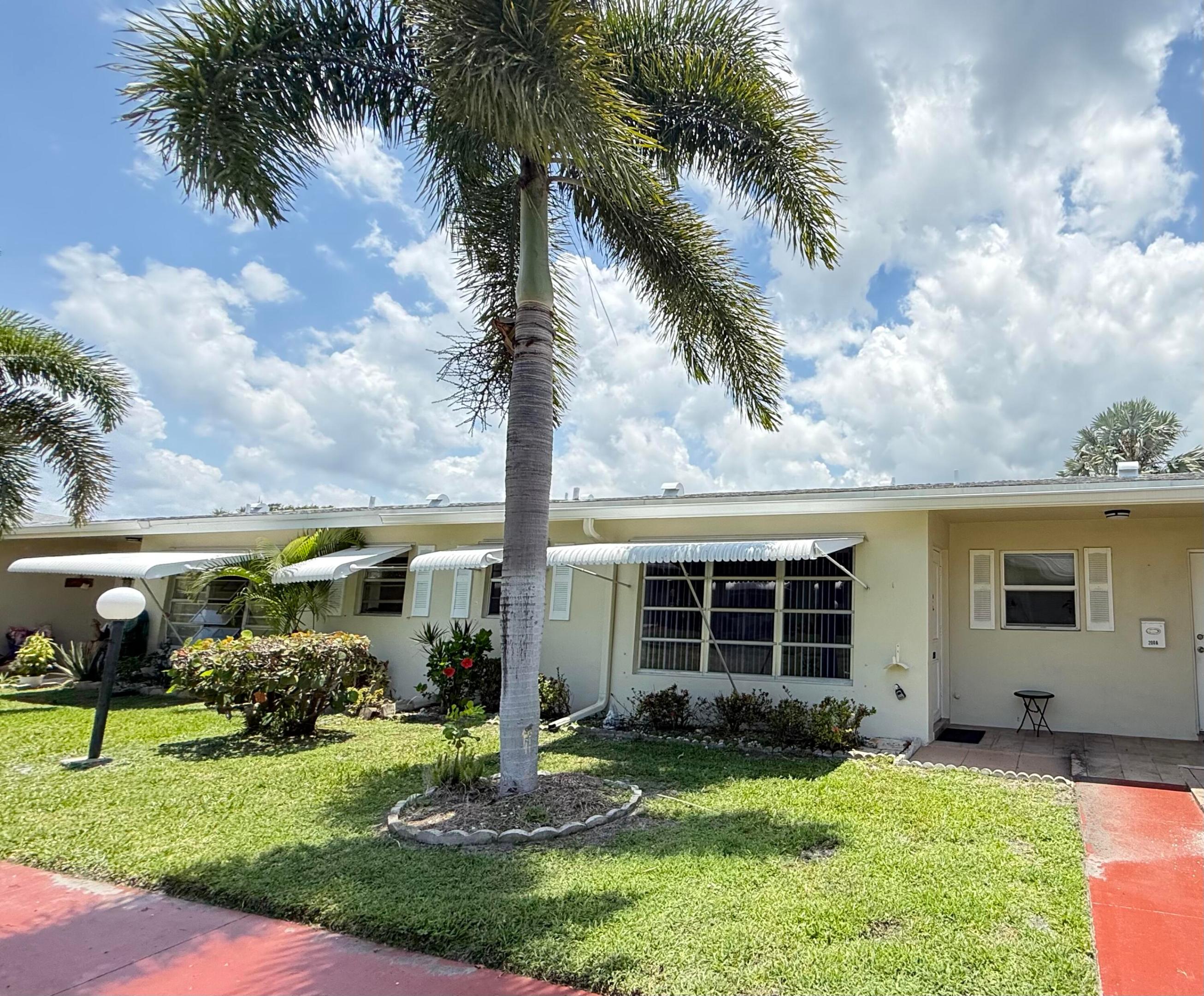 Great 55+community, 1bed 1.5bath, first floor villa. Bright and light with renovated open kitchen. Spacious living area, oversized master, 2 walk in closets. Florida room that can be used as a den/office/or second bedroom, plenty of storage. Only 4 units per building, outside laundry only 4 steps away from the back door, no coins needed, laundry room serves just only the 4 units. The entire community was painted and roofs were redone in 2021 & 2022. A/C is 2024 and new water heater was just installed Community Clubhouse with many activities to suit your lifestyle, it offers heated pool, shuffleboard, billiards,card room and a social room for gatherings. Minutes from the beach, I-95, PBIA, malls, City Place. EASY TO SHOW!  HOA $502/month includes cable, internet, water, trash, and amenities