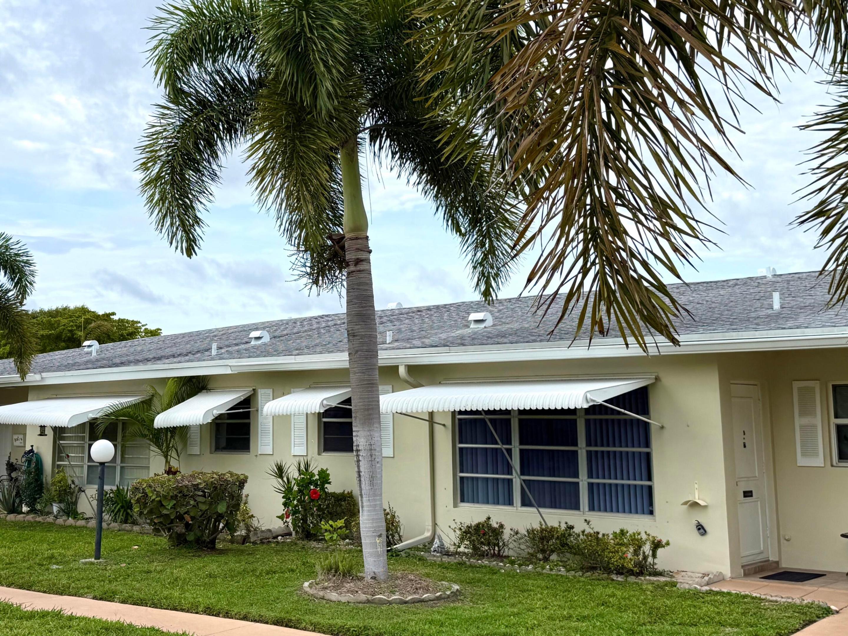Great 55+community, 1bed 1.1bath, first floor villa. Bright and light with renovated open kitchen. Spacious living area, oversized master, 2 walk in closets. Florida room that can be used as a den/office/or second bedroom, plenty of storage. Only 4 units per building, outside laundry only 4 steps away from the back door, no coins needed, laundry room serves just only the 4 units. The entire community was painted and roofs were redone in 2021 & 2022. A/C is 2024 and new water heater was just installed Community Clubhouse with many activities to suit your lifestyle, it offers heated pool, shuffleboard, billiards,card room and a social room for gatherings. Minutes from the beach, I-95, PBIA, malls, City Place. EASY TO SHOW!  HOA $502/month includes cable, internet, water, trash, and amenities