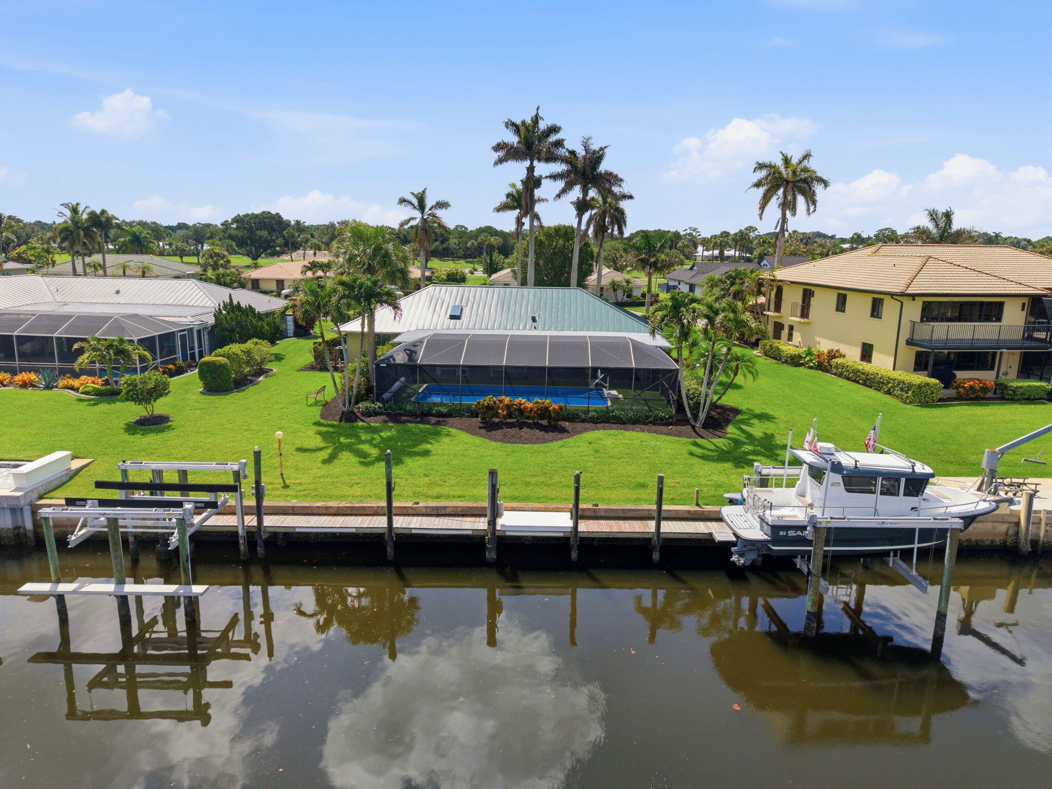 Boasting over 100 ft of water frontage, 2 boat lifts & a heated pool, this home is a boater's dream. Located in the prestigious Stuart Yacht & Country Club (membership not required), this 3 bed, 2 bath, 1891 sqft cbs home sits on .29 acres & is only a 20 minute boat ride to the St. Lucie Inlet/Atlantic Ocean. The dock is outfitted with a 16,000 lb (2021) & 10,000 lb (2023) boat lift. The pool was resurfaced in 2025 & is complemented by a screened patio perfect for entertaining. Recent upgrades include a new metal roof (2024), partial impact windows, new AC & air handler (2021), & an updated irrigation system (2025). Optional Y&CC membership offers golf, tennis, pickleball, & a full activities calendar. Close to downtown Stuart, the beach, Manatee Pocket, shopping, dining, schools & highway