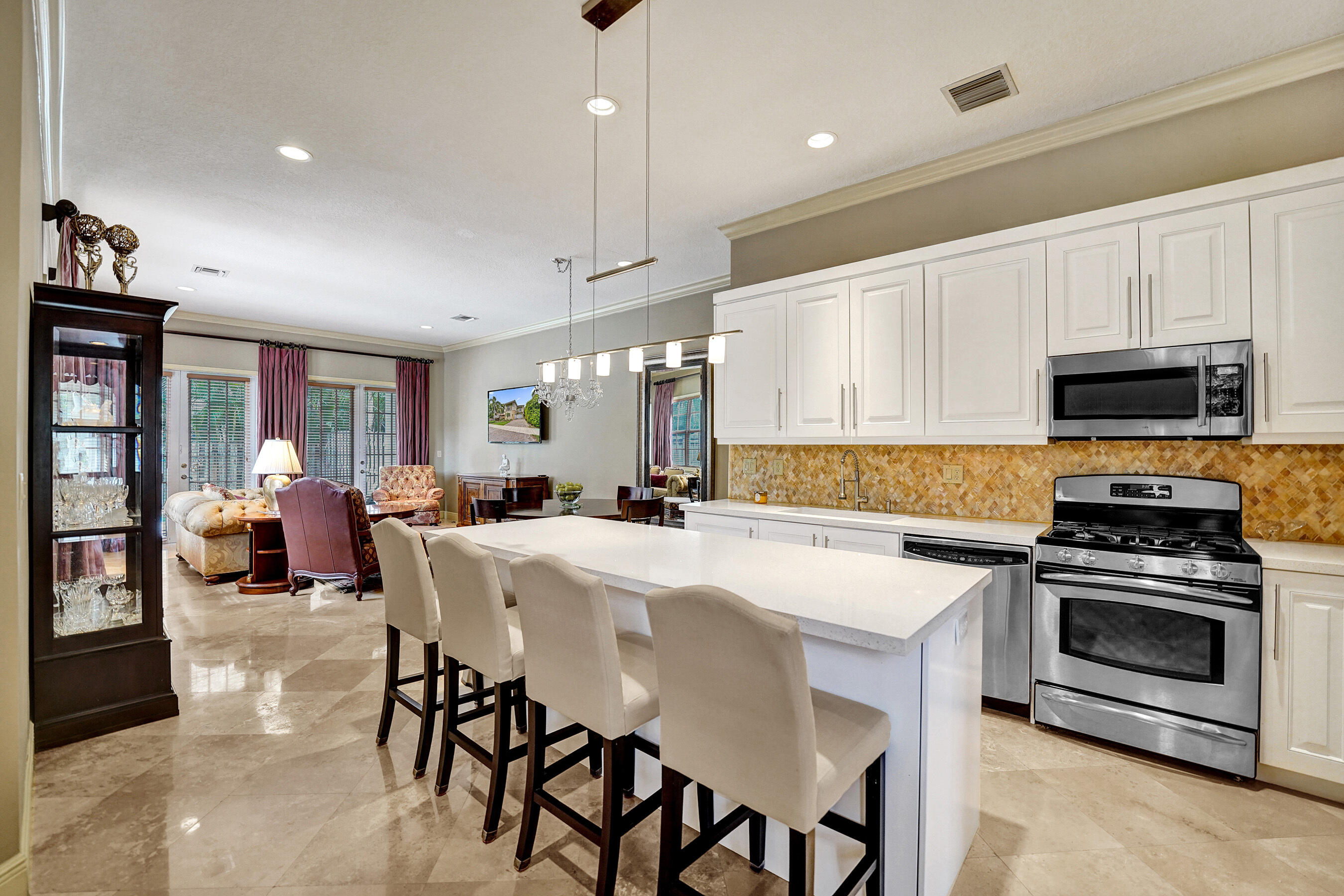 Experience elevated South Florida living in this stunning 3-bedroom, 2.5-bath residence offering 2,652 SQFT under air and 3,085 total SQFT of thoughtfully designed space. Soaring 12-foot ceilings downstairs and 11-foot ceilings upstairs create an open, grand atmosphere throughout the home. A sophisticated blend of marble and wood flooring pairs seamlessly with high-end finishes and designer details. Built for both comfort and peace of mind, the property features hurricane impact windows and doors, a spacious 2-car garage, and a private backyard retreat complete with a spa — perfect for relaxing or entertaining. Ideally located just moments from Wilton Drive, enjoy walkable access to vibrant bars, restaurants, shopping, and nightlife while still being centrally located to everything.