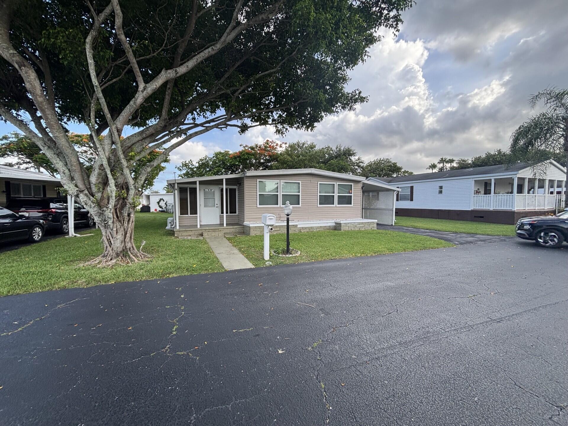 BEAUTIFUL AND SPACIOUS HOME, RENOVATED WITH 2 BEDROOMS, 3 BATHS AND AN ENCLOSED FLORIDA ROOM WITH A SEPARATE ENTRANCE, THAT COULD BE A 3RD BEDROOM. SOLD WITH THE FURNITURE AND NEW WASHER AND DRYER. HOME IS LOCATED IN DEERFIELD LAKE, A BEAUTIFUL 55+ COMMUNITY, ONLY A FEW MILES TO THE DESIRABLE BEACH OF DEERFIELD.  LOT RENTAL $1,062.71 MONTHLY.  IT CAN BE FINANCE.