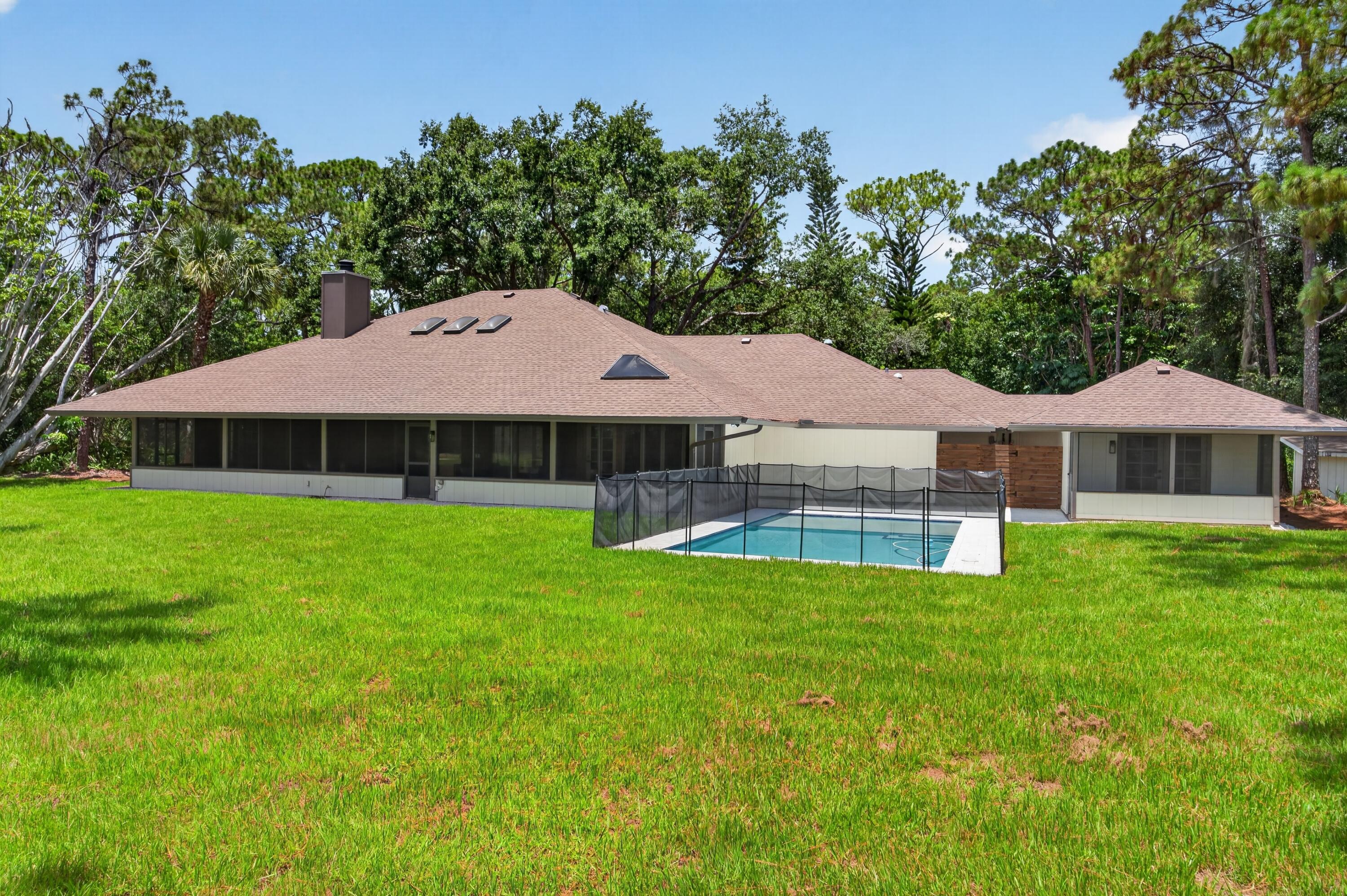 Completely remodeled and move-in ready, this exceptional home in the prestigious Crane Creek community of Palm City offers luxury, privacy, and space on a private wooded 2 plus acre lot. Every detail has been thoughtfully updated, including a brand new kitchen, all completely renovated bathrooms, new flooring, fresh interior paint, a refurbished expansive patio, and a stunning new pool. Designed with comfort and functionality in mind, each bedroom features its own en-suite bath, making this home ideal for large or multigenerational families. Located within a gated, golf-friendly community featuring two clubhouses with dining and entertainment, residents enjoy both exclusivity and convenience. Just minutes from top-rated Martin County schools, shopping, dining, and everyday essentials. The community boosts two 18 hole golf courses, including one private and one public course. This remarkable property combines modern luxury with peaceful estate-style living.