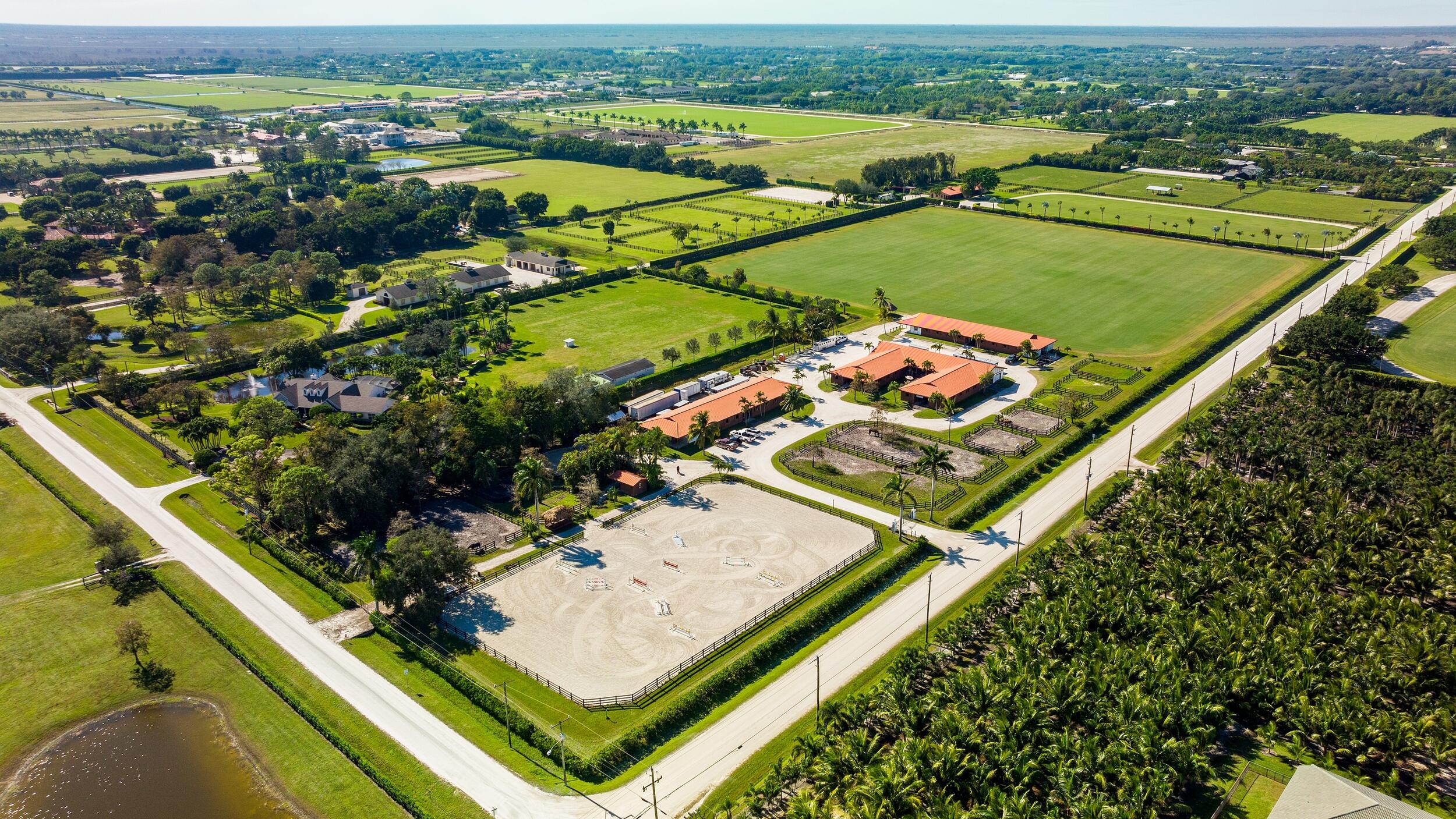 Equestrian enthusiast opportunity! Stunning 15-acre estate with 3 barns and a total of 52 stalls. Property has a 10-acre Bermuda grass field and a fully irrigated 140 x 240 arena. 11 grass paddock and a 60' Round Pen with fiber footing. 2 studio apartments with a lounge, 5 tack rooms, 5 feed rooms, 6 wash stalls and plenty of storage. Located close to all Equestrian Venues. Within minutes to WEF, Global Dressage and International Polo.