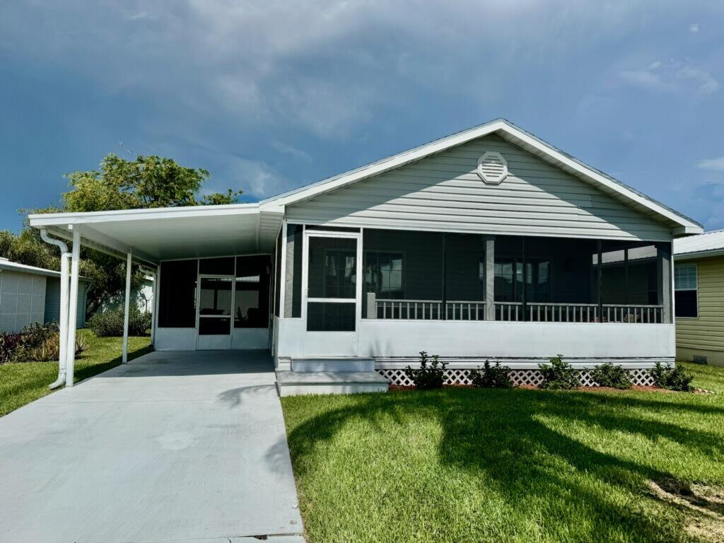 PALM VILLAGE RANCH ~ Beautifully remodeled MODULAR Home. Bright and cheery retirement living! From the lighting to the LVP flooring, enjoy the newness and style of this sweet home.  New SS appliances, solid surface counters, farm sink and backsplash, pantry. New doors and new hardware throughout.  Front Screened lanai with wrap around porch. Side screened porch and carport.  New A/C and landscaping.  55+ Community.  Community Pool, Clubhouse, Activities. HOA/ 72mo. A HONEY OF A HOME!