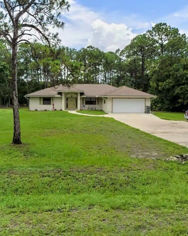 Enjoy peaceful country living in Jupiter Farms with this charming 3-bedroom, 2-bath single-family home located on a paved road just minutes from town. Filled with natural light, the home features a bright layout with several freshly repainted rooms for a clean, refreshed feel. The spacious yard offers plenty of room to enjoy the outdoors, while the screened-in patio is perfect for relaxing year-round. A great opportunity to enjoy privacy, space, and convenience in one of Jupiter Farms' most desirable locations.