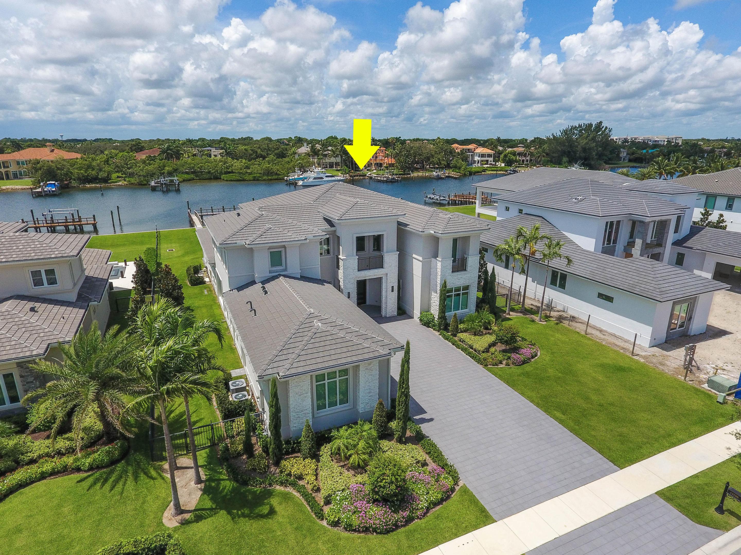 This stunning Transitional Modern estate home is located on over half an acre of pristine waterfront property in the private enclave of Frenchman's Harbor. 
No stone was left unturned in its immaculate construction and tastefully appointed professional décor. A grand entry way delivers a palatial experience with its two-story foyer and floor to ceiling glass windows, which flood the home with natural light. This 5 bedroom, 5.5 bath home features two master suites, one on the ground floor and one on the second floor, as well as two separate living spaces. The gourmet kitchen boasts high-end finishes and top of the line appliances from Jenn-Air , Subzero and  WOLF. Enjoy effortless entertainment with the open floorplan, luxe living spaces and a full wet bar, all looking out onto the expansive backyard and the Intracoastal waterway.  The downstairs master suite is bright and airy and features coffered ceilings, crown molding, bay windows, backyard and pool access via French doors, his and hers walk-in closets, solid wood floors and its very own exercise room. The master bath includes dual vanities, a spa bathtub, oversized walk-in shower and a separate W.C. 

Upstairs is a home of its own, with a large loft-style living space, a second master suite, two additional bedrooms and private balconies. Other home features include a fully integrated AV system, ample storage space throughout (mud room, pantry, under-stairs storage, etc.) and a spacious 3-car garage. This home creates a seamless atmosphere between outdoor and indoor living, with a covered lanai featuring retractable phantom screens and full summer kitchen, a cabana bath, heated pool and spa, large yard and 45 foot private dock. Enjoy the effortless boating lifestyle with easy ocean access and no fixed bridges. Perfectly situated in North Palm Beach, this home is one of only 48 single family homes in Frenchman's Harbor and is located near PGA Boulevard's finest dining, shopping, golf, boating and just minutes from Florida's beautiful beaches.