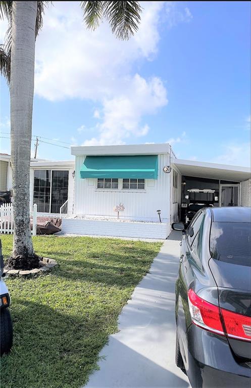 Absolutely gorgeous 2/1.5 single wide with pushout that looks like a double wide - -carport - shed - screened in area - split bedroom plan - - beautiful wood laminate floors throughout - - great curb appeal - -fenced in area - -assoc. states it is HOPA verified - - priced right for quick sale - -