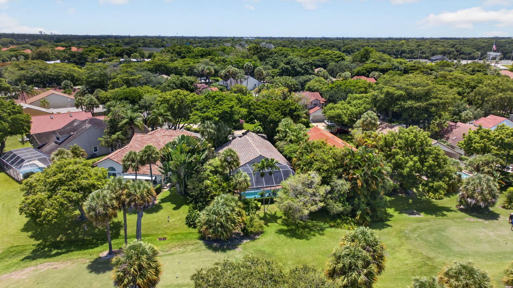 Priced for a quick sale! Own this beautiful, elegant & spacious 3-bedroom, 2.5-bathroom pool home with a large 2-car garage and spacious paved driveway. The residence is situated on the golf course surrounded by a lush, enchanted tropical garden, making it a true Florida dream. A vaulted ceiling characterizes the heart of the home, featuring expansive living and dining areas overlooking the inviting enclosed pool and the golf course. The primary suite is voluminous, extending to a dignified bathroom. Of the two additional bedrooms: 1 has an en-suite bathroom, and the other shares a convenient one-half bathroom with guests. An extra-large separate kitchen with a breakfast area pulls this home together, creating a cozy, warm, and peaceful atmosphere.