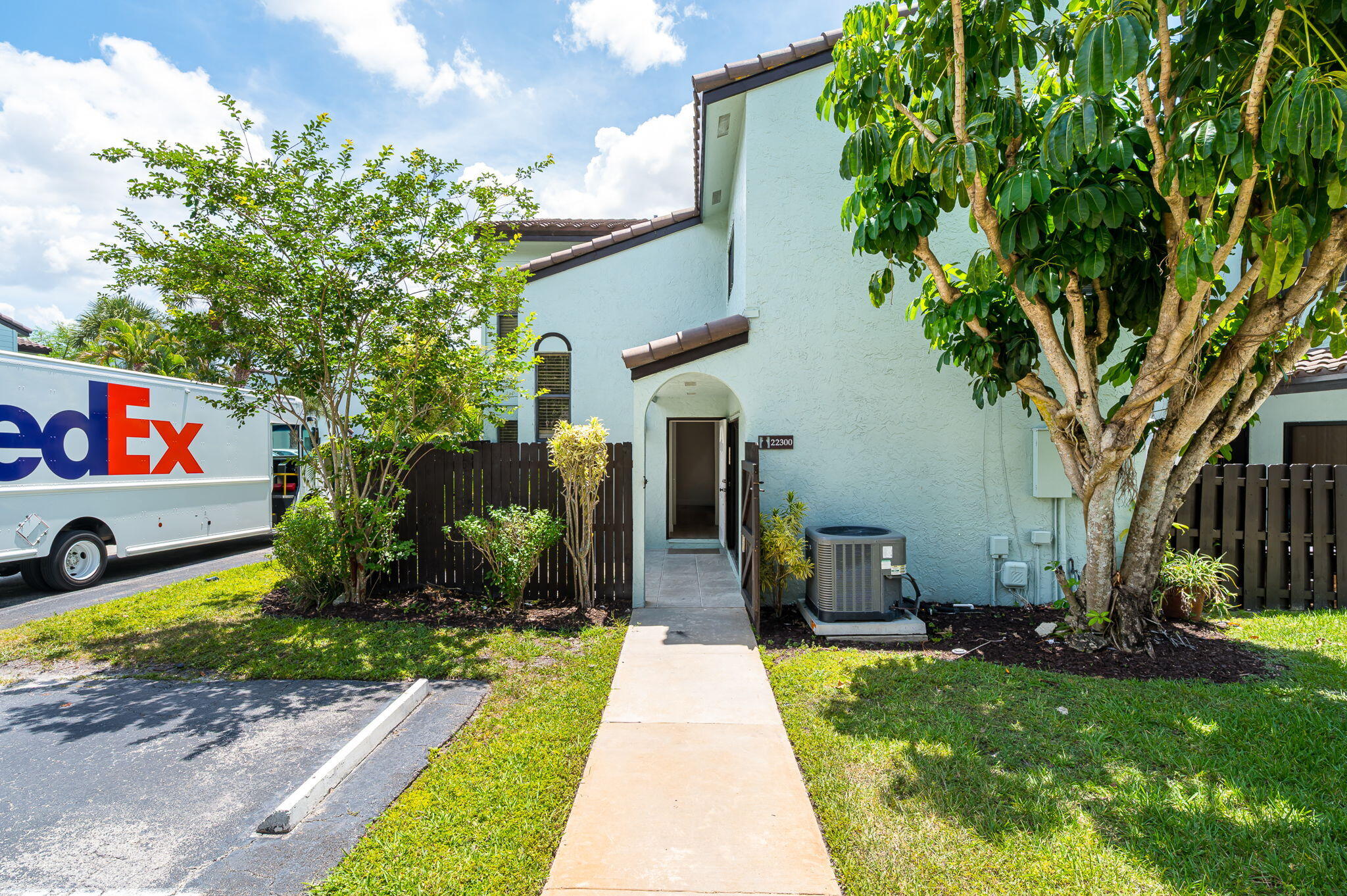 Pineapple Walk community of Boca Raton. This inviting residence features two private courtyards, including a charming tiled front-entry courtyard and a second secluded courtyard offering additional outdoor living space and privacy. Beautifully updated two-story townhouse located in the desirable  The updated kitchen is appointed with granite countertops and stainless-steel appliances. Upstairs, you'll find two spacious bedrooms, while the first-floor office/den can be enclosed to serve as a third bedroom, providing flexibility to suit your needs. Recent improvements include fresh interior paint, new flooring throughout both levels, and a newly updated staircase. One assigned parking space is included, and pets are welcome. Ideally situated within walking distance of Publix, The Grove, shops, and restaurants. Town Center at Boca Raton, major medical facilities, and other conveniences are just minutes away.