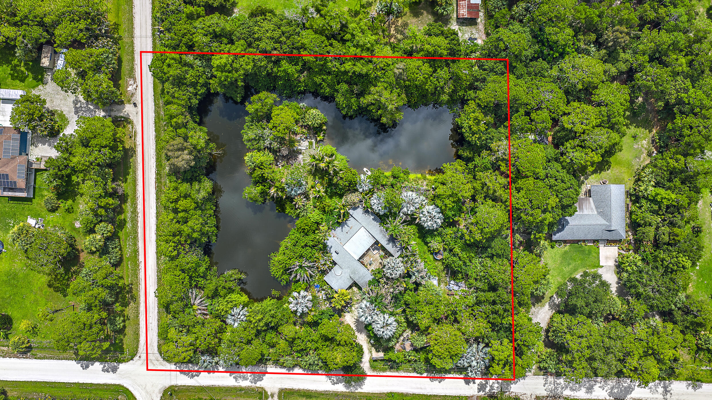 Listing price reflects lot value. Fantastic opportunity to build your dream home on 2.5 acres! 5 minutes to Publix in the front of Jupiter Farms. 100 yards off a paved road. Corner lot with a pond stocked with fish for the fishing enthusiast!