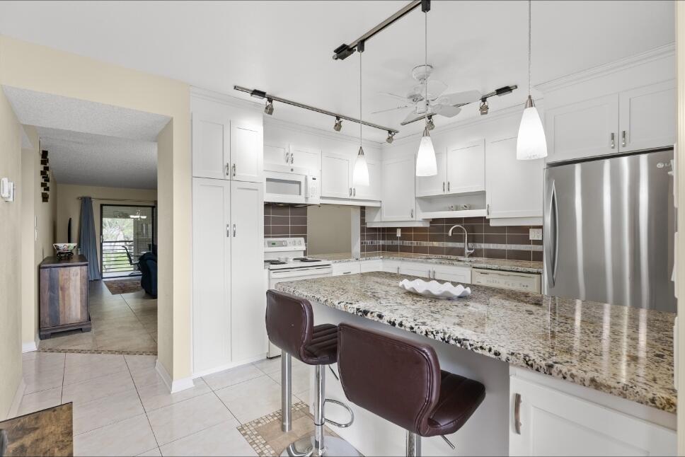 Welcome to your new home, desirable 55+ Lakes of Carriage Hills in Tamarac! This spacious 2BR/2BA condo is tastefully updated and move- in ready. Features include a modern kitchen with granite countertops, updated cabinetry, two renovated bathrooms with granite, and tile flooring throughout. Enjoy central air, ceiling fans, window blinds, and an exterior walk-in closet. Relax on your private patio, perfect for morning coffee or evening breezes. Community amenities include a pool, sauna, clubhouse with fitness center, tennis and pickleball courts, picnic areas, and walking paths. HOA covers all amenities for easy, low-maintenance living. Conveniently located near shopping, dining, golf, parks, medical centers, and just a short drive to Fort Lauderdale beaches. Credit Score required 620.  Seller shall credit Buyer $5,000 at closing toward Buyer's closing costs, prepaid expenses, and/or allowable lender fees. This credit is contingent upon Buyer's lender approval and may not exceed actual closing costs.