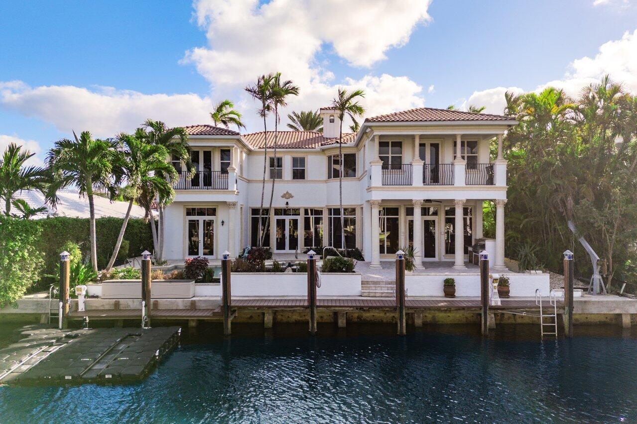 Stunning waterfront 6BD 5.5BA situated along a serene canal off Lake Rogers, with direct access to the Intracoastal Waterway. Marble floors flow throughout the downstairs area leading from a well-appointed guest bedroom through a Jack-and-Jill bathroom and into an impressive office featuring a grand, wooden built-in. The spacious kitchen boasts a large walk-in pantry, paneled appliances, and an expansive island, ideal for culinary creations. Adjacent to the kitchen, the living room offers a seamless view of the outdoor area, where two glass doors open to a covered patio. Additionally, find a downstairs wine cellar with classic custom wood built-ins and a beautiful mosaic window. Outside, enjoy a stunning pool, a deck, and ample patio space, perfect for hosting or relaxing. Read more.... Upstairs, the luxurious primary suite features two generous walk-in closets, a private balcony overlooking the canal, and an opulent marble bathroom. Two additional upstairs bedrooms each have their own en-suite bathrooms, one of which includes a balcony with tranquil canal views. A versatile upstairs office can function as a gym, den, or workspace to suit your needs. Added convenience includes washer and dryer setups both upstairs and downstairs. Just minutes from downtown Boca Raton and a short walk to Spanish River Boulevard, this residence offers the perfect blend of convenience and tranquility. Enjoy easy access to upscale shopping and dining, all within the charm of an intimate, peaceful community.
