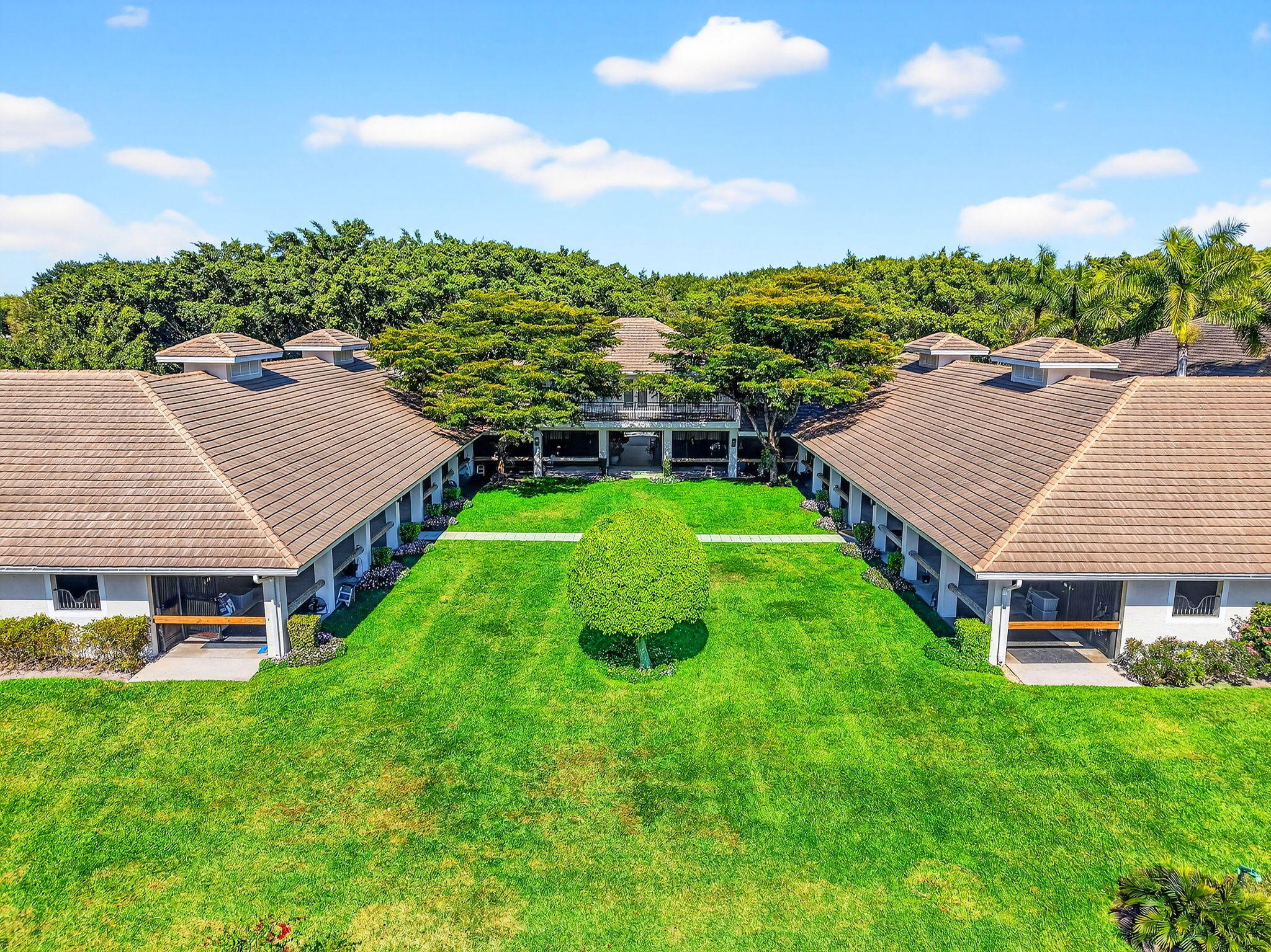 Idyllic and refined, this premier equestrian farm blends luxury, privacy, and top-tier performance facilities on one of the most desirable triple lots in Grand Prix Village. A rare find, the property offers a short hack directly to the show, set within a serene, sprawling landscape framed by mature clusia hedges, established palms, and meticulously maintained grounds. The farm features an exceptionally spacious main barn with 58 12' x 12' stalls, plus additional overflow stalls out back. The barn showcases custom, high-end stall fronts, three well-appointed tack rooms, and two professional arenas, one sand and one all-weather, complemented by a new hot walker and a round pen with premium footing. Designed to support high-level training, competition, and boarding, the property Designed to support high-level training, competition, and boarding, the property includes 14 paddocks, multiple wash stalls, double laundry rooms, abundant storage, a large vet and farrier stall, and dedicated outlets for therapeutic equipment. Additional amenities include a large utility building, hay and shavings storage, an ice machine, and a discreet, sealable manure bin that maintains a clean, fly-controlled environment. The residence offers multiple apartments totaling 13 bedrooms and a new roof installed in 2023. Ideally positioned within Grand Prix Village, a gated equestrian community renowned for its luxury estates in the heart of Wellington's equestrian community.