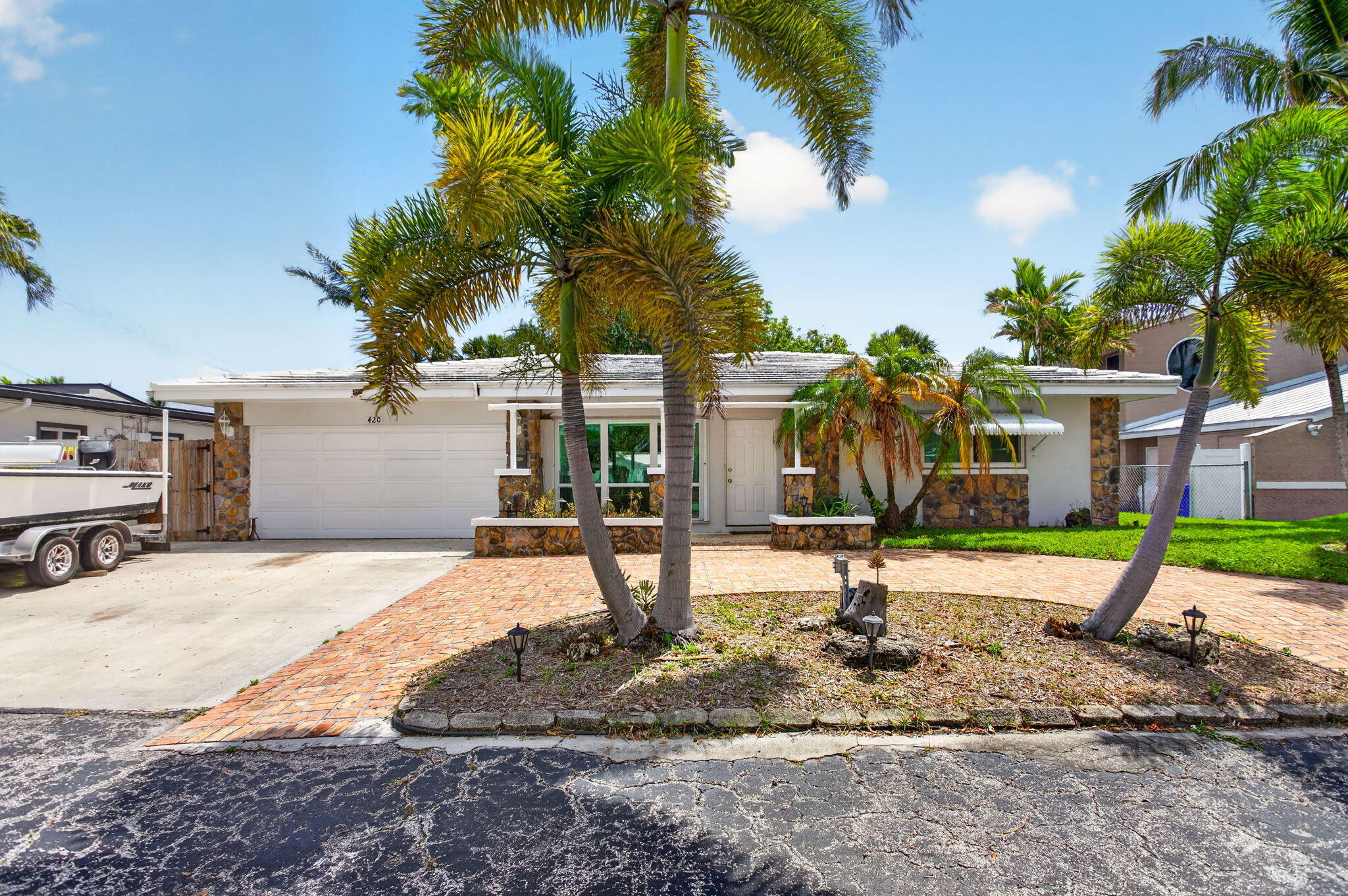 Experience the quintessential South Florida lifestyle in the highly desirable Snug Harbor community. This waterfront gem is a true boater's retreat, boasting 70' of water frontage and a private 50' dock. Just five minutes by boat to Lake Santa Barbara and the Intracoastal, you are perfectly positioned for days on the water with easy Atlantic access via one fixed bridge (Federal Hwy). This 2/2 home with a 2-car garage is a blank canvas for your creative vision. Nestled on a quiet dead-end street with a fenced yard and NO HOA, you have total freedom to customize your retreat. Enjoy being minutes from the revitalized Pompano Pier district, world-class beaches, and dockside dining. Own a piece of the coast and build the waterfront lifestyle you've always imagined. Bring boat and vision today!