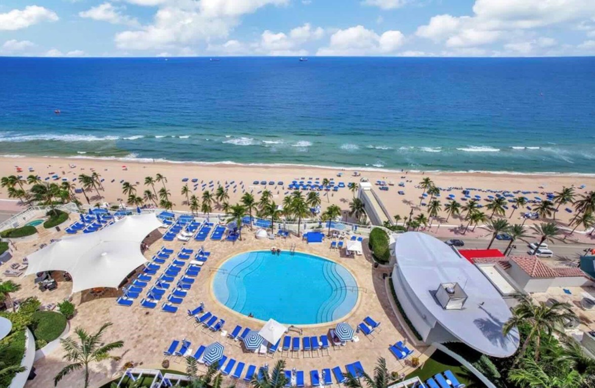 Direct Ocean views glimmer at entry of this Ritz-Carlton Residential Suite. The property offers the best in comfort &nautical glamour experiencing the ultimate in amenities! Fresh florals greeting one upon arrival in the grand lobby, a 10,000 sq ft spa & state of the art fitness center. Enjoy beach side breakfast, lunch & dinner ocean side at BurlockCoast or lunch at the pool bar suspended over the Atlantic. In-room dinning is at one’s finger tips. Beach & PoolButlers provide ultimate service. On-property designer boutiques and coffee bar complete all of the luxuriousmoments without ever leaving the property. Currently in the hotel rental program; all rentals are managed by thehotel. The rental program is flexible for unlimited owner use and optional to participate.