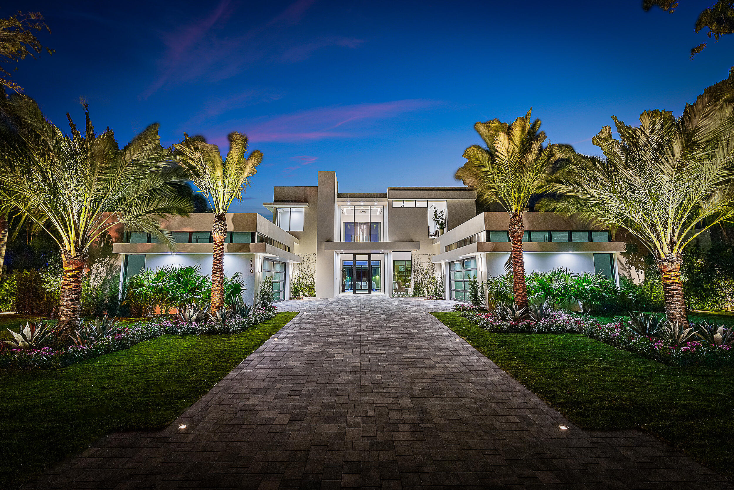 Welcome to 410 Mariner Drive, a contemporary waterfront masterpiece in the prestigious enclave of Admirals Cove. Featuring 7,998 sq ft of interior living space and a total living area of 12,253 sq ft, this new build seamlessly blends modern design with unparalleled amenities, making it the epitome of waterfront opulence. Outdoor bliss awaits as you step into the captivating 75-ft Euro Edge infinity pool, complemented by a champagne spa and sundeck, creating a lavish waterfront retreat. The meticulously designed lanai, boasting a summer kitchen and outdoor gas fireplace, seamlessly connects the interior with the picturesque surroundings, while the private dock with deep water access caters to boating and yachting enthusiasts.

A striking atrium serves as the centerpiece of the residence, enveloping it in natural light. This impressive space includes an enchanting water feature with floating steps, producing a tranquil and distinctive indoor-outdoor atmosphere.

Indoors, 410 Mariner Drive reveals sophisticated features, including smart home technologies, a primary kitchen equipped with Miele appliances and custom Italian cabinetry, a butler's pantry hosting a fully equipped secondary kitchen, and an elevator for added convenience. The master suite boasts spa-like amenities, featuring separate His and Hers bathrooms and closets, along with stunning waterfront views. Dual laundry rooms add practicality to daily living. The 4-car garage supports electric vehicle charging and offers ample height for car lifts, catering to the needs of car collectors.

410 Mariner Drive represents a rare opportunity within the highly sought-after Admirals Cove enclave to acquire a newly constructed masterpiece that establishes the pinnacle of contemporary luxury and exclusivity. Don't miss the chance to claim this one-of-a-kind residence.