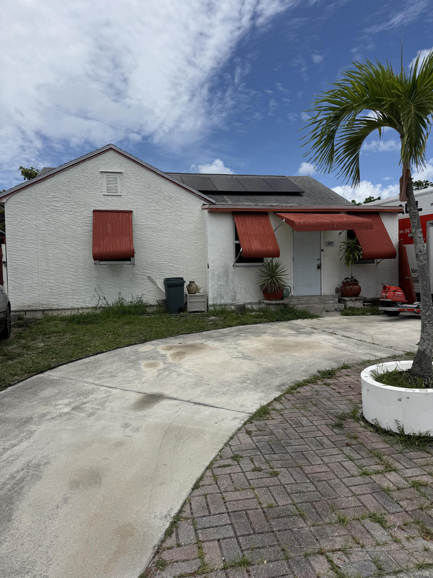 Two bedroom, two bath home with a two-car garage located near downtown Lake Worth. Features include impact windows, solar panels, and multiple private entrances offering excellent flexibility for rental income or multigenerational living. The backyard is equipped with water and sewer hookups for an RV, adding even more versatility to the property. With some TLC, this home has incredible potential for an investor or end user looking to make it their own in a prime location close to shopping, dining, beaches, and entertainment.