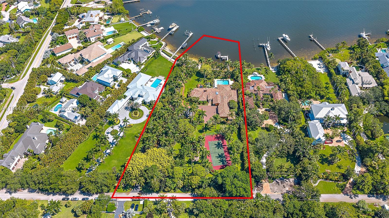 Set on over 2.5 acres with approximately 200 feet of direct riverfront, this stunning estate is one of the most extraordinary properties ever offered on prestigious Pennock Point. Situated on the highly sought-after and rarely available lots along the picturesque Loxahatchee River, the property enjoys panoramic water views and is enveloped in mature, tropical landscaping that offers unmatched privacy and a natural, estate-like setting that is increasingly rare in South Florida.  The property offers direct riverfront access with a 90-foot dock, ideal for intracoastal and ocean-bound boating. Dock your boat in the backyard and cruise the scenic Loxahatchee River, head out to the ocean, or stop at Jupiter's top waterfront restaurants. Whether you choose to build a legacy residence, explore subdivision opportunities, or move into the existing home, the possibilities are endless.  The estate features luxurious amenities including a separate guest quarters, heated pool, and private tennis courts. The main residence boasts six spacious bedrooms, seven baths, a study, library, and an elegant formal dining room, providing the perfect blend of comfort and sophistication for both everyday living and entertaining.  Pennock Point is one of Florida's most desirable waterfront enclaves, known for its expansive lots, peaceful riverfront lifestyle, and close proximity to everything Jupiter has to offer. Top-ranked golf clubs such as The Bear's Club, Jupiter Hills, and Apogee are just a short drive away, making this an exceptional location for golf enthusiasts who also value life on the water.  Jupiter offers something for everyone, from miles of unspoiled beaches and scenic nature trails to world-class dining, boutique shopping, vibrant local arts, and top-rated schools, all just minutes away. Whether you're raising a family, entertaining guests, working remotely, or simply seeking a peaceful retreat, this property delivers the perfect blend of luxury, privacy, convenience, and South Florida waterfront living at its finest.