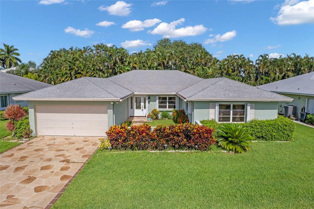 Extremely Sought After Pine Tree Village 3 bed, 2 bath, 2 car garage home in this 55+ Community. All windows have hurricane shutters, beautiful stamped concrete driveway. From the front door spreading throughout the home is beautiful, newly installed, large format tiles. New kitchen cabinets, countertops and stainless appliances add to the recent upgrades in addition to the bathroom renovations as well. Toward the back of the home is a large enclosed Florida Room that can be used for entertaining and adds to the overall under air sqft. As you step outside you will notice the paver sitting areas and a automatic retractable awning to keep you shaded in the summer. The home has a spacious open layout, lots of storage with closets around every corner.