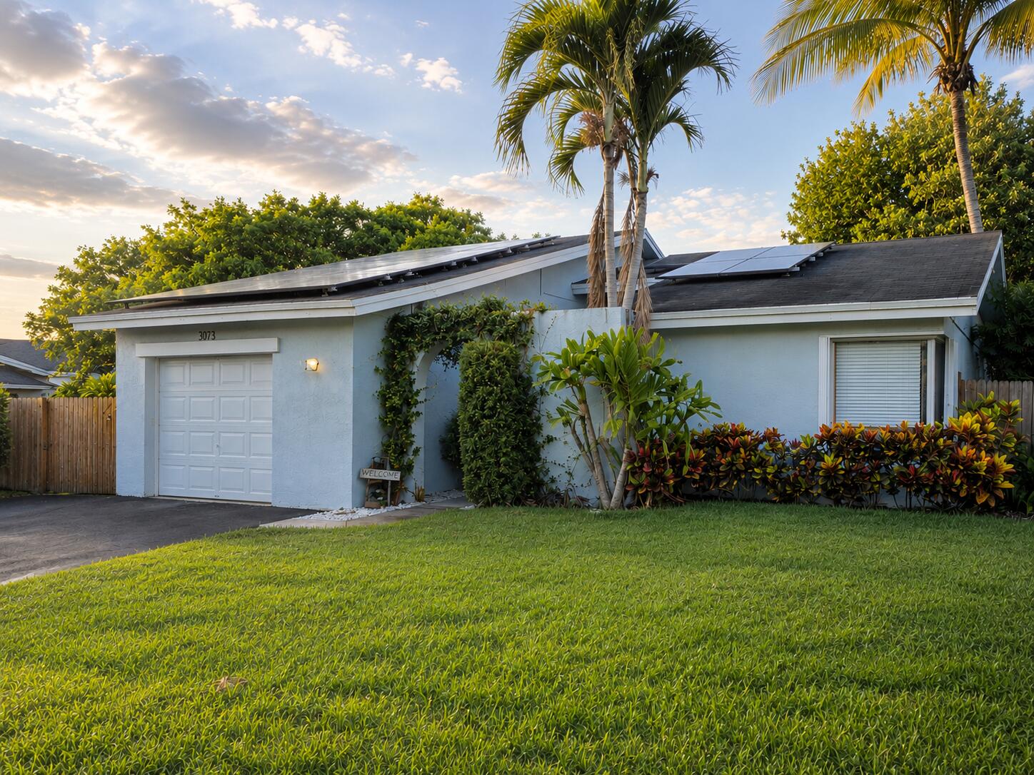 Discover a home where the true centerpiece is its spectacular tropical backyard. This 3-bedroom, 2-bathroom single-family home offers the perfect balance of comfort and entertainment with a spacious open-concept living and dining area that creates a bright and inviting atmosphere. Step outside to your private oasis featuring a saltwater pool, built-in BBQ, generous entertaining areas, and direct lake access the perfect setting for relaxing or hosting friends. The kitchen features granite countertops, stainless steel appliances, waterproof vinyl flooring throughout, and an air-conditioned garage with vinyl flooring for added comfort and versatility.  Solar panels provide significant energy savings by reducing monthly electricity costs. The HOA offers fast approval  Ideally located in The Gates of Hillsboro, just minutes from Quiet Waters Park, top-rated schools, restaurants, shopping, and with convenient access to major highways. The HOA offers fast approval, no application fee, and no minimum credit score requirement.