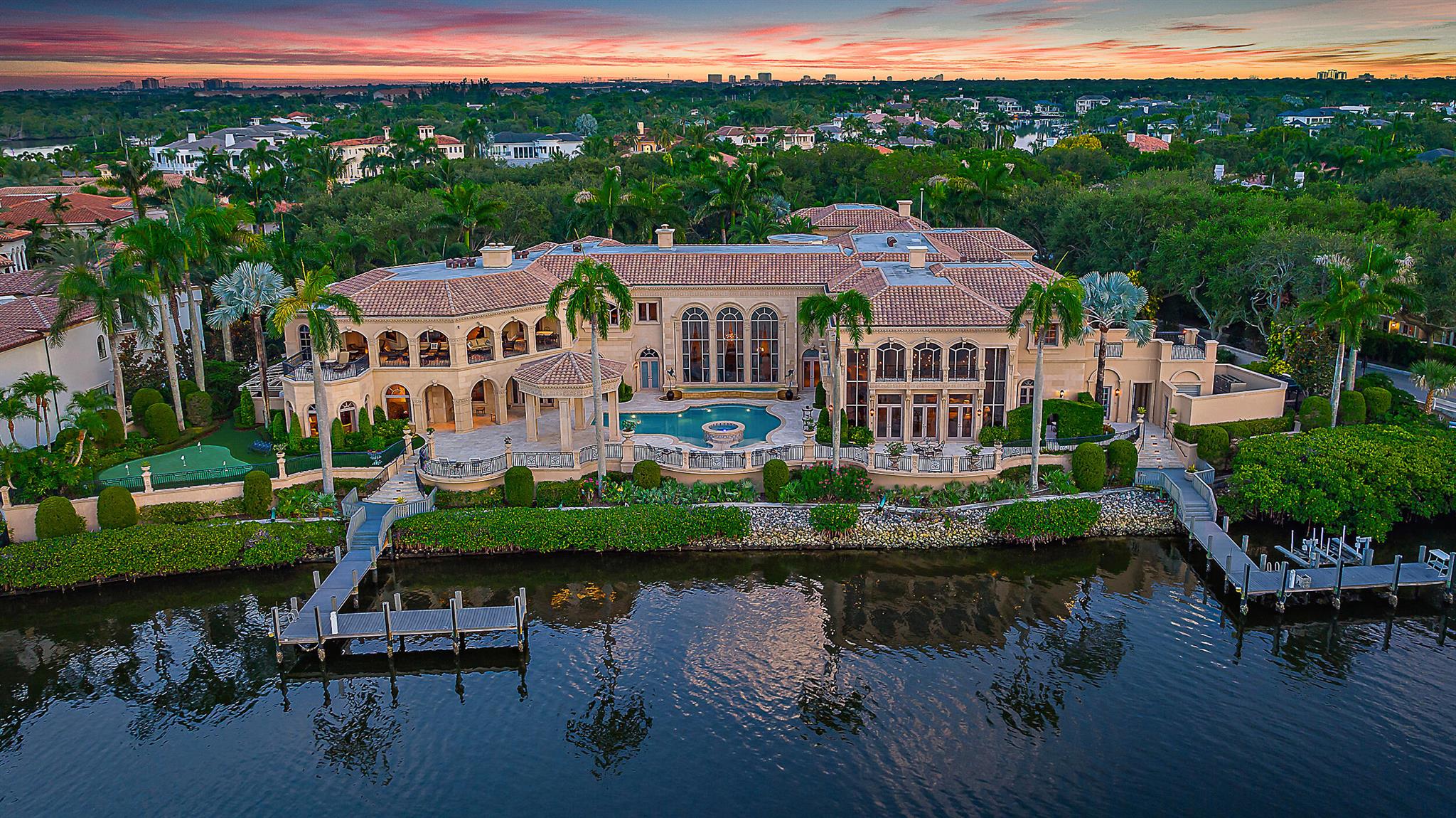 Welcome to this palatial estate in the prestigious Admirals Cove, offering an unparalleled blend of luxury and serenity on the Intracoastal. Boasting an expansive 300 feet of prime waterfrontage, this masterpiece of design and craftsmanship features 9 grand bedrooms and 13 lavish baths, providing ample space for both relaxation and entertainment. The timeless interior exudes sophistication, with each room meticulously crafted to reflect elegance and comfort. The estate includes a separate 3-bedroom guest house, perfect for hosting visitors while ensuring privacy. For car enthusiasts, a 6-car garage offers abundant storage and security.
Outdoor living is elevated with two private docks, ideal for accommodating large yachts or multiple watercraft. If you love to entertain on a grand scale this home is for you. A  complete catering kitchen and wet bar on the main level, dining room that will accommodate a large dinner party, alfresco dinning on the patio or upstairs in the club room with decedent woods, space seating areas, pool table all with unparalleled views of the Intracoastal.  Enjoy the tranquility of waterfront living, in this estate in Admirals Cove that delivers an extraordinary lifestyle beyond compare.