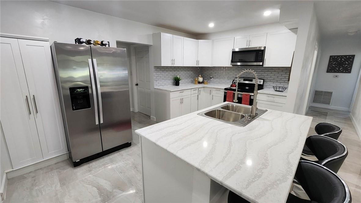 Are you looking for the perfect place to call home? Look no further!!!! This beautiful home features 4 bedrooms and 2 baths on on an EXTREMELY OVERSIZED lot. This has been renovated with new kitchen, upgrade bathrooms. New paint interior and new tile floors.  READY for a new owner. Park your RV or Boat, NO HOA! Room for a pool, tennis or bocce court or ALL three!!!! HUGE patio area and FULLY fenced yard for to resume family gatherings with the kids and fur babies. Kitchen with breakfast counter, family room, dining area and formal living room. Purchase as a primary residence or an investment and rent it for about $4000+/mo. No restrictions! No HOA !!! Ready to move in. This one won't last.