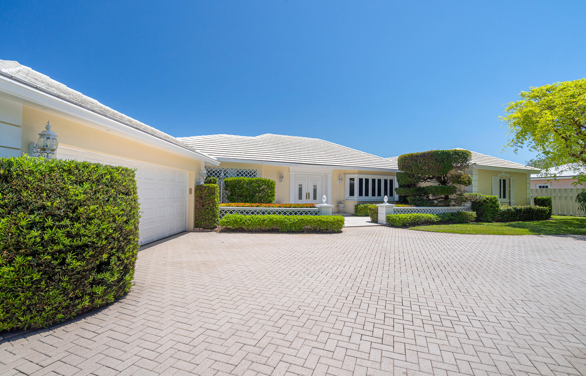 Bermuda inspired charm meets true coastal exclusivity in the gated Village of Sea Ranch Lakes—one of Florida's most private, police protected enclaves with its own oceanfront Beach Club. Cherished by the same family for decades, this elegant home offers grand flowing living spaces, forever views of Lake Cayuga, Italian marble, warm wood floors, a gourmet kitchen with Butler's Pantry, split bedrooms, full house generator, over-sized pool w/sun shelf and A/C garage. A rare opportunity to shape a legacy property in a community where 24/7 private police create a level of safety so complete that children can roam freely, with a members only Beach Club, playground, and private beach access just moments from fine dining and shopping.