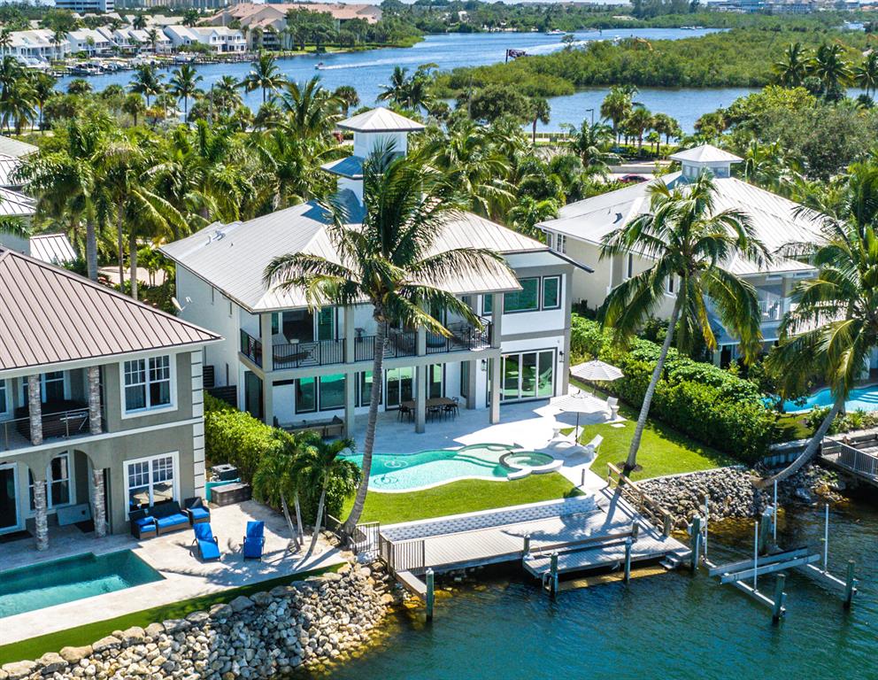 Lands End is a private gated riverfront enclave of only 8 homes. This Key West Style waterfront home has been masterfully reimagined, redesigned and totally reconstructed down to the studs adding 532 square feet to the living area.  This location is one of the few areas that have the Caribbean turquoise blue waters of the Loxahatchee River and unobstructed panoramic views.  The Jupiter Inlet is only minutes away. Enjoy exceptional sweeping water views from almost every room. Some of the many features include volume ceilings, impact windows & sliding doors providing sweeping wide river views, extensive custom cabinetry, built-ins, and the highest quality appliances throughout. Whether entertaining or enjoying quiet family dinners, the open concept gourmet kitchen, breakfast room, dining room and family room with fireplace all enjoy stunning wide water views. The chef's kitchen features high end " Fulgor" European appliances from Milan, which include a stainless-steel gas stove, refrigerator, two dishwashers, and plenty of custom cabinets and an oversized island that seats six.  In addition, the large downstairs bedroom is perfect for guest privacy. 

The second floor features an expansive private Owner's retreat.  The elegant bath features double vanities, large shower and soaking tub, and spacious walk-in closet.  The owner's suite and two additional bedrooms are separated by a multi-functional room that can be used as a second family room, office, additional guest bedroom or playroom.  Both the first and second floor offer a large covered patio for relaxation, entertaining and spectacular sunset views.

The backyard oasis features a tropical style pool, outdoor shower, dock with 16,000 lb. lift and its own private putting green.  Conveniently located just minutes to the Jupiter Inlet, the best restaurants, beaches, and shopping Jupiter has to offer!