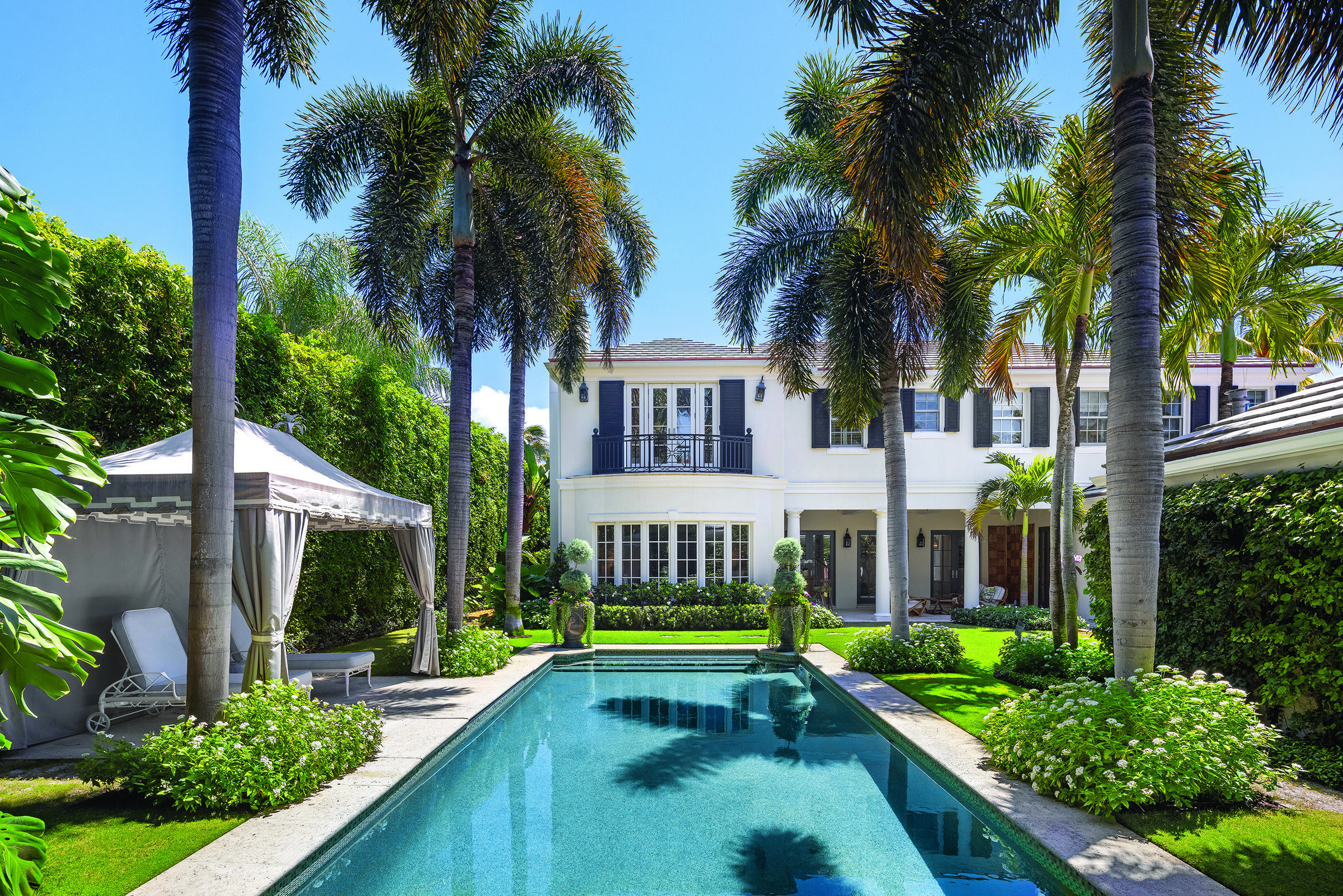 Welcome to 231 Coral Lane, a quintessential Palm Beach retreat where warmth, elegance, and effortless indoor-outdoor living come together in perfect harmony. Tucked behind tall, manicured hedges and surrounded by lush, tropical landscaping curated thoughtfully by Nieverra Williams, this private estate, set on a large oversized lot, captures the relaxed sophistication that defines island life. Inside, sun-filled spaces and timeless design span 6,294 total square feet, creating a home that feels both expansive and intimately inviting. This warm retreat boasts a sensational floorplan, with four bedrooms, an office, formal dining and a stunning formal living space with bay windows facing the pool. The upstairs primary suite is a serene sanctuary, complete with dual baths and separate his-and-her closets.  Entertain with ease in the formal dining room, or retreat to the private office space. The heart of the home opens seamlessly to the outdoor living areas, where a sparkling pool and charming cabana create your own private oasis.  A two-car garage, beautiful architectural details, and a layout designed for functionality, relaxation, and entertaining complete the offering. At 231 Coral Lane, every day feels like a getaway, blending classic Palm Beach style with the comfort of home.    DISCLAIMER: Information published or otherwise provided by the listing company and its representatives including but not limited to prices, measurements, square footages, lot sizes, calculations, statistics, and videos are deemed reliable but are not guaranteed and are subject to errors, omissions or changes without notice. All such information should be independently verified by any prospective purchaser or seller. Parties should perform their own due diligence to verify such information prior to a sale or listing. Listing company expressly disclaims any warranty or representation regarding such information. Prices published are either list price, sold price, and/or last asking price. The listing company participates in the Multiple Listing Service and IDX. The properties published as listed and sold are not necessarily exclusive to listing company and may be listed or have sold with other members of the Multiple Listing Service. Transactions where listing company represented both buyers and sellers are calculated as two sales. "No payments made until title passes" Some affiliations may not be applicable to certain geographic areas. If your property is currently listed with another broker, please disregard any solicitation for services. Information published or otherwise provided by seller, listing company or its representatives is deemed reliable but are not guaranteed and subject to errors, omissions, or changes without notice. Copyright 2026 by the listing company. All Rights Reserved.