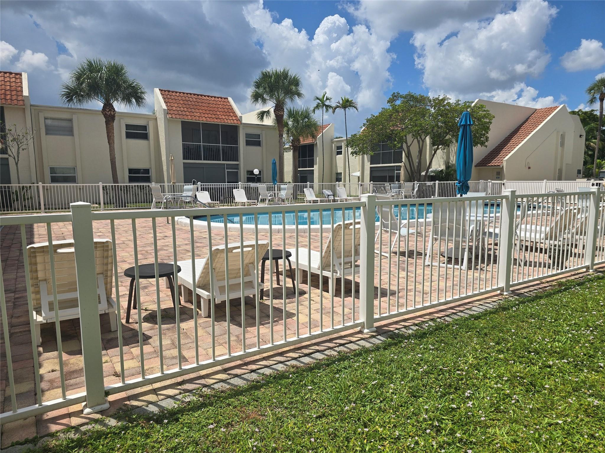 This residence offers 1,000 square feet of finished living space thoughtfully designed to maximize comfort and functionality.  Walk out of your sreened in patio and you are at the pool.  New AC 2024, Garbage Disposal 2023, Dishwasher 2024, Flooring and Baseboards 2025.  The screen on the patio is also new and the unit has been freshly painted.  Plus, there is a washer/dryer combo in the unit.  Perfect place to live.  Close to shopping, restaurants, and beach